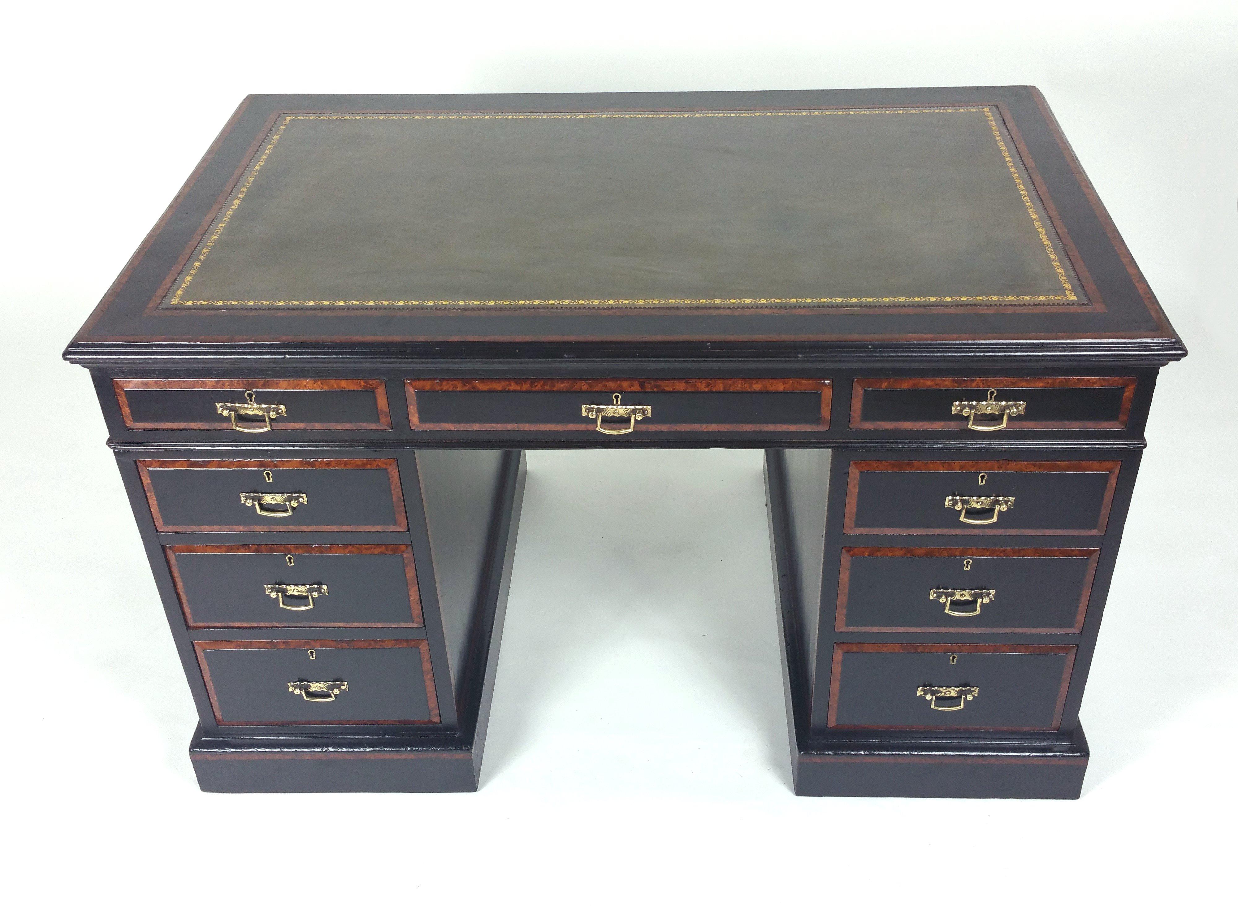 This gorgeous and very sleek looking 19th century. Aesthetic Movement pedestal desk features an ebonized finish with amboyna crossbanded detailing and original brass handles. It measures 48 in- 122 cm wide, 29 in – 73.7 cm deep and 29 in- 73.7 cm in