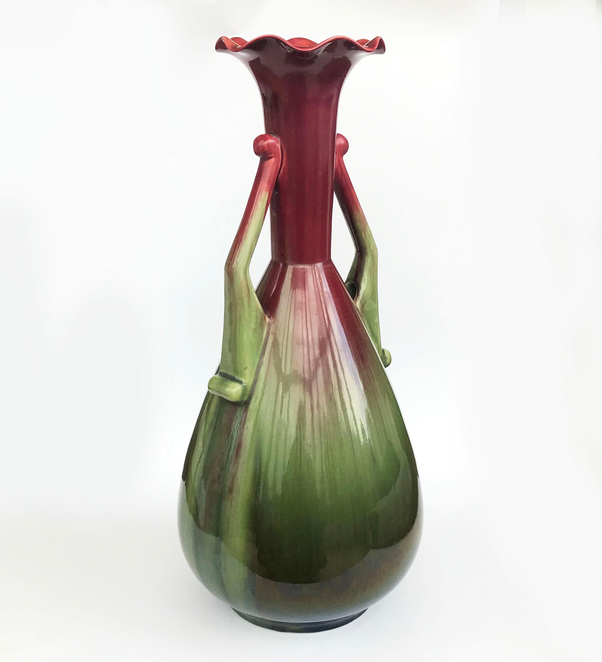 A wonderful monumental Linthorpe Art Pottery vase designed by Christoper Dresser circa 1882. The design is a powerful Dresser shape depicting power, the handles reminiscent of arms with hands on hips, the two handled body decorated with deep red and