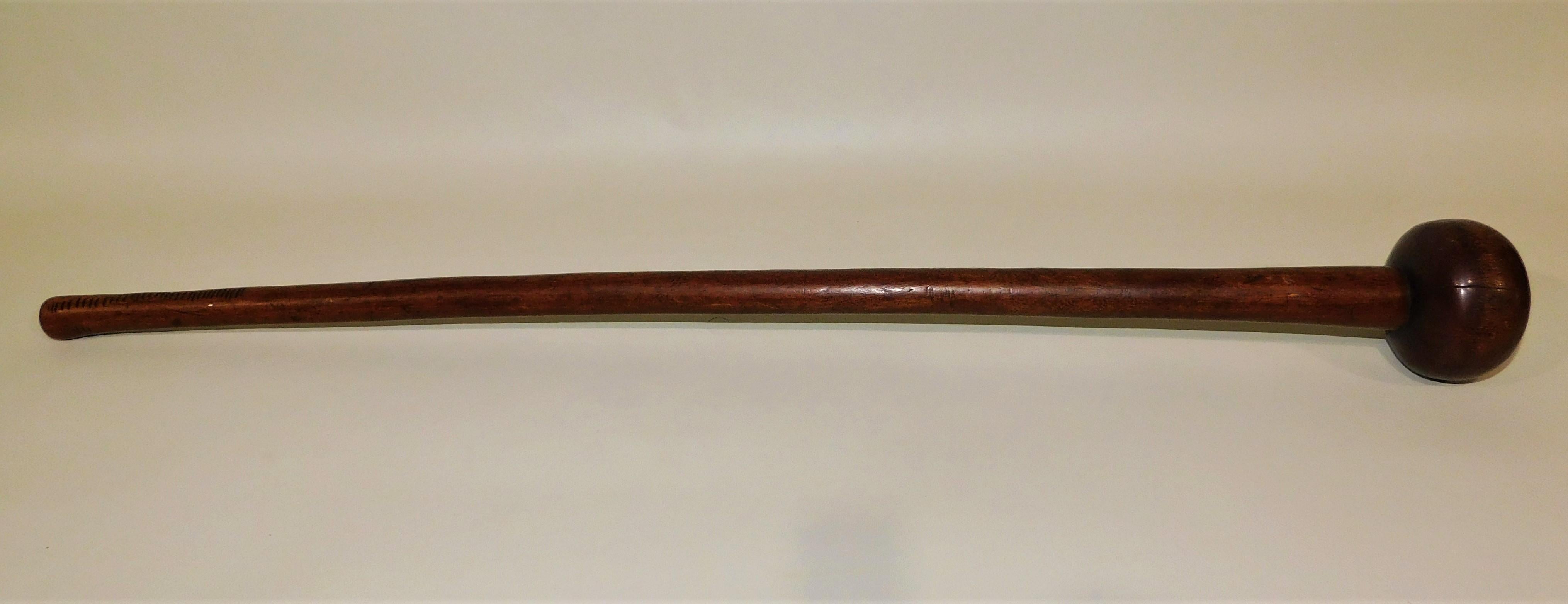 19th century Zulu war club known as a Knobkerrie made from the wood of a root ball or wad and carried by Zulu warriors in South Africa. Made from the hard wood of a root ball of a tree or ironwood, with the shaft carved from just one limb, making it
