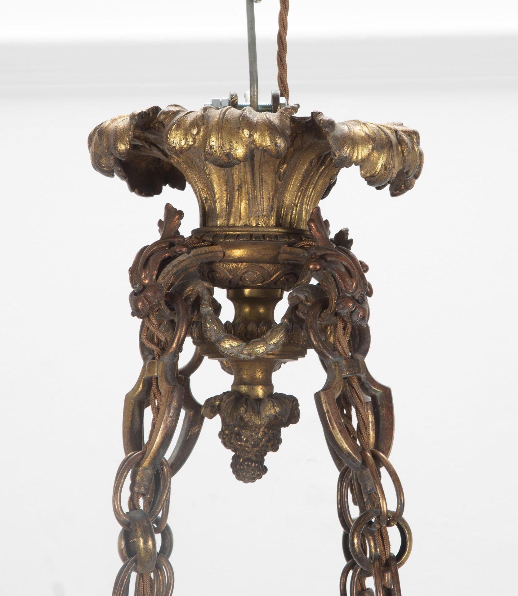 An impressive 19th Century English gilt bronze and alabaster country house plafonnier.

The finely cast ceiling boss with flowing acanthus leaves, swags and berries, supporting four heavy chains with shield-shaped links holding four twin-branch