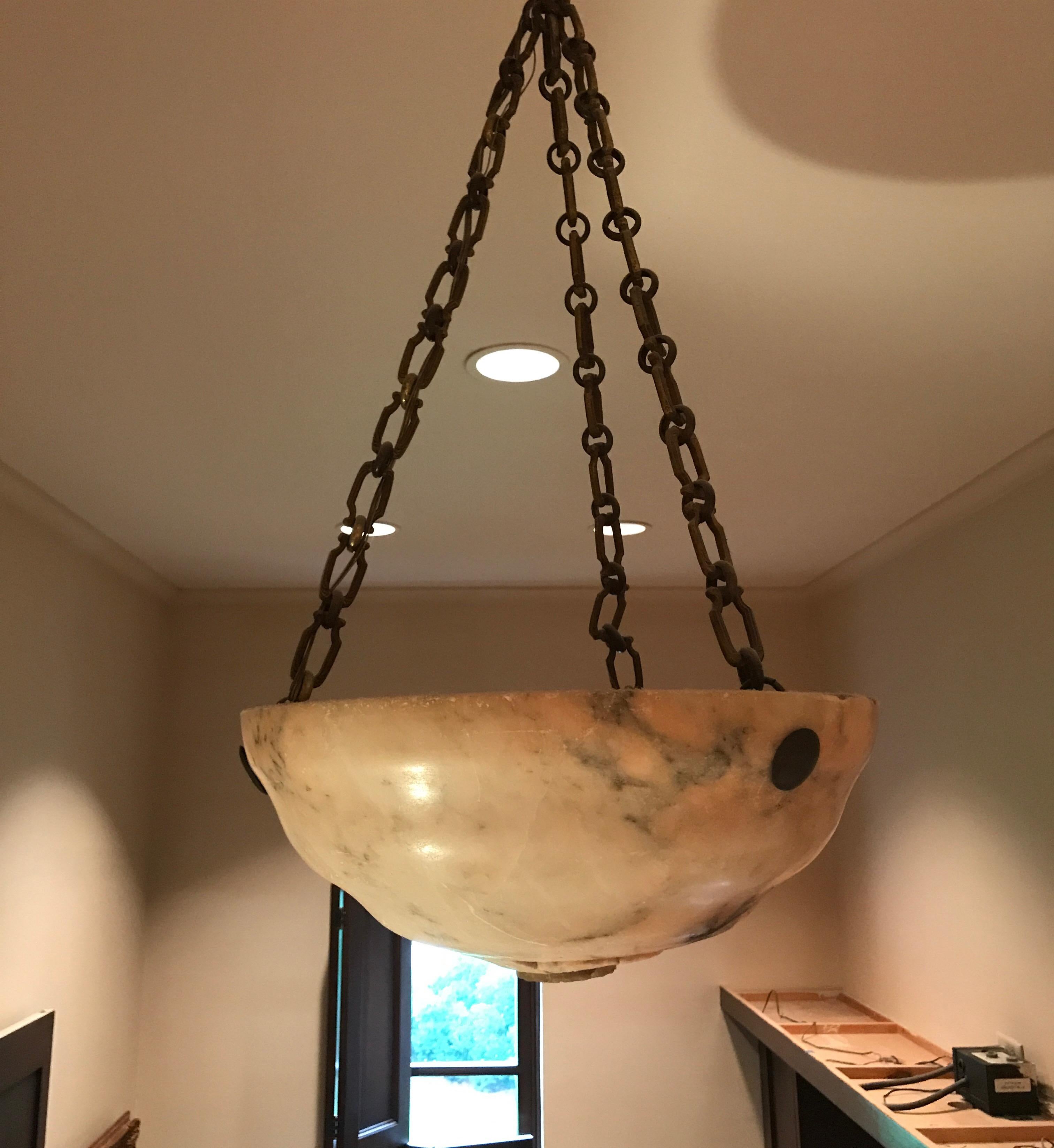 19th century Alabaster bowl chandelier with brass link chain. The bowl also has carving on the bottom with brass medallion. The alabaster is a beautiful color of blush terracotta.