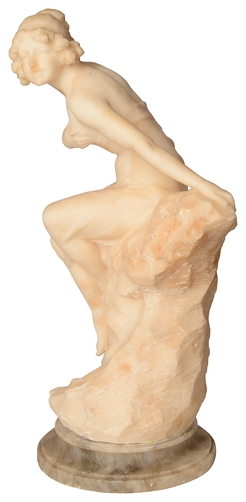 A good quality 19th century alabaster statue of a semi nude young girl sitting on a rock.