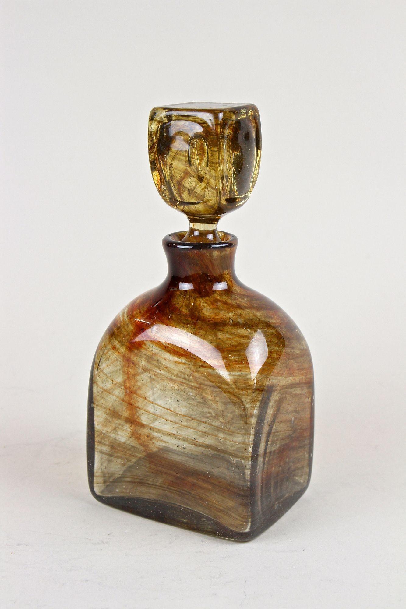 One of a kind mouth blown Glass/ Liquor Bottle from the period around 1870 in Austria. An absolute fantastic crafted bottle made of amber colored glass. A beautiful and highly decorative piece of Austrian glass art adorned by those special melted,