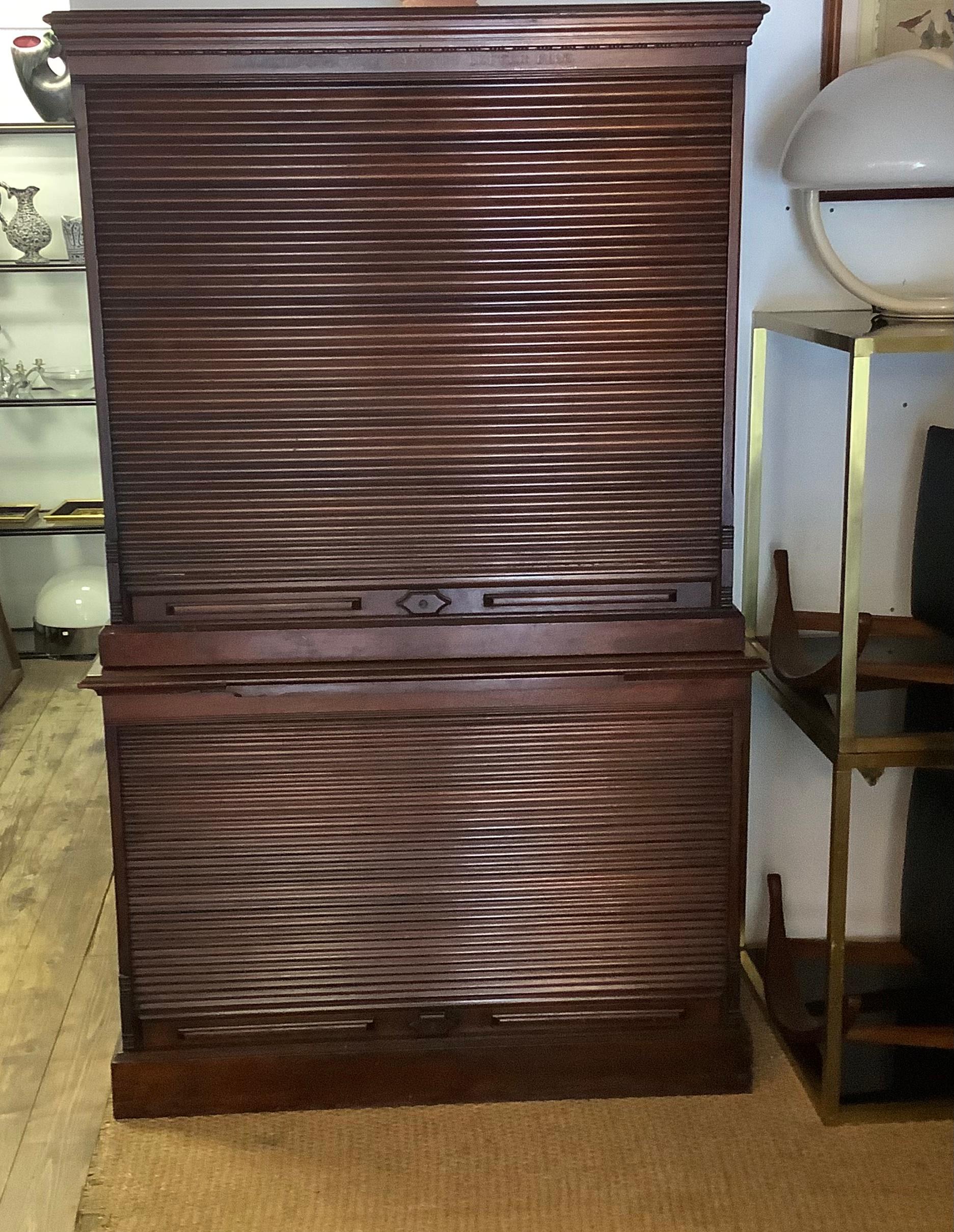 Made by Amberg of America, this 19th century Mahogany cabinet letter files has a bank of 24 drawers, each with their original metal clips and a pair of tambour front. Two cabinets the base has single shelf with the top 24 storage filing draws.