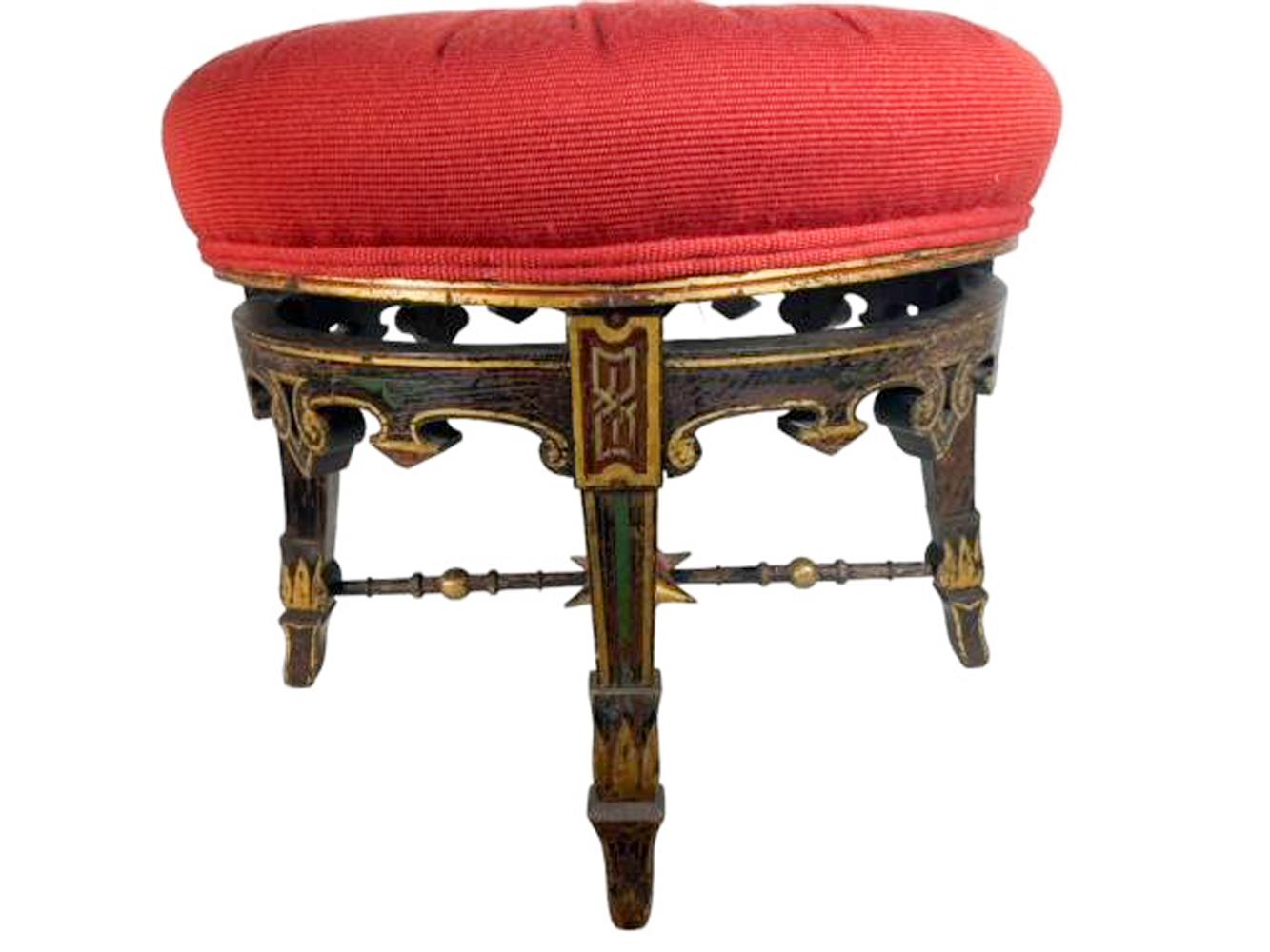 American Aesthetic Movement footstool on four tapered legs below a shaped and pierced apron, the legs connected with ball and ring turned x-stretcher centering a large red sphere with gilded spikes. The original faux rosewood painted wood frame with