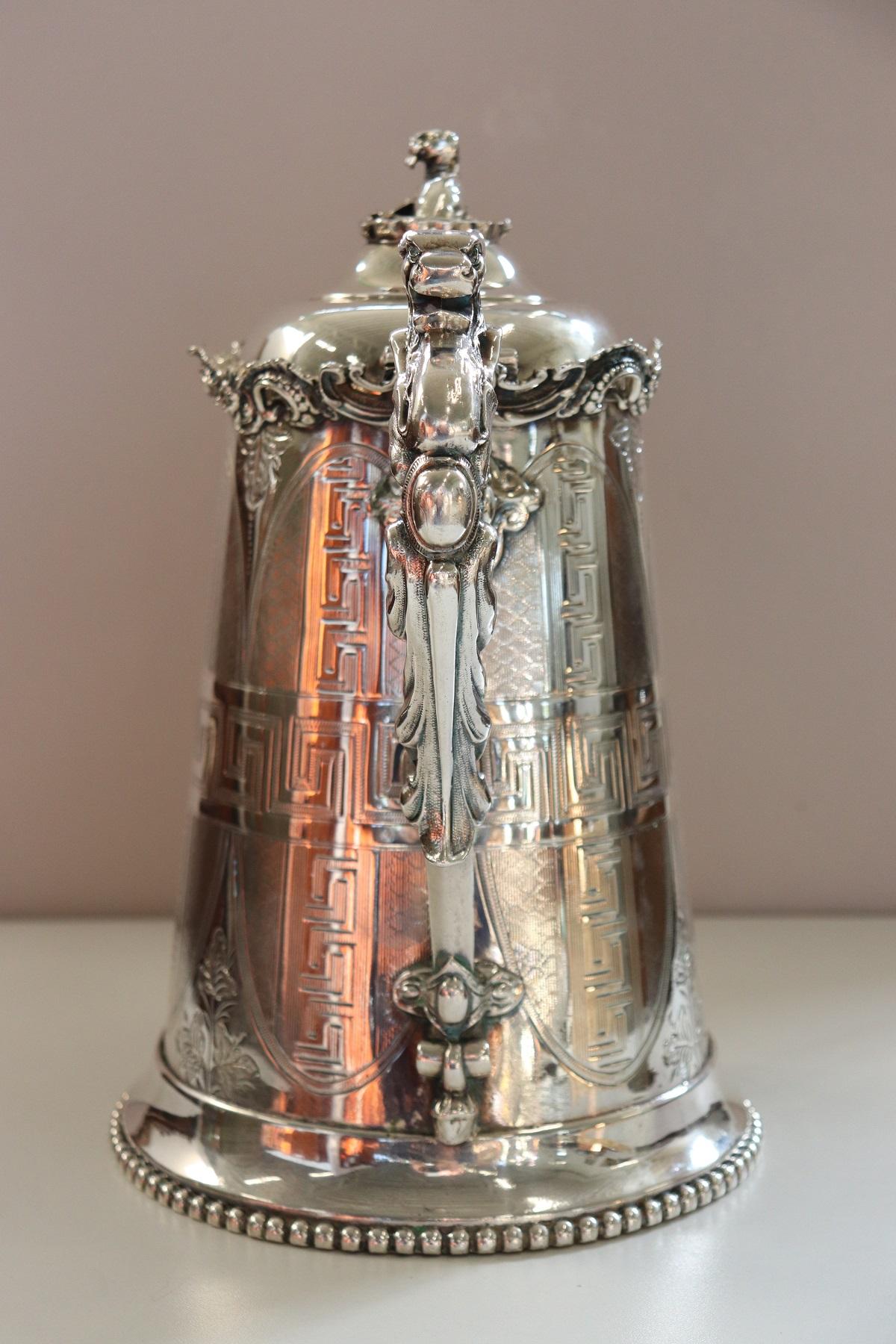 Beautiful american antique silver plate pitcher by Ernest Kaufman. Great chiseling work in the metal look carefully at the refined decoration. On front engraved 