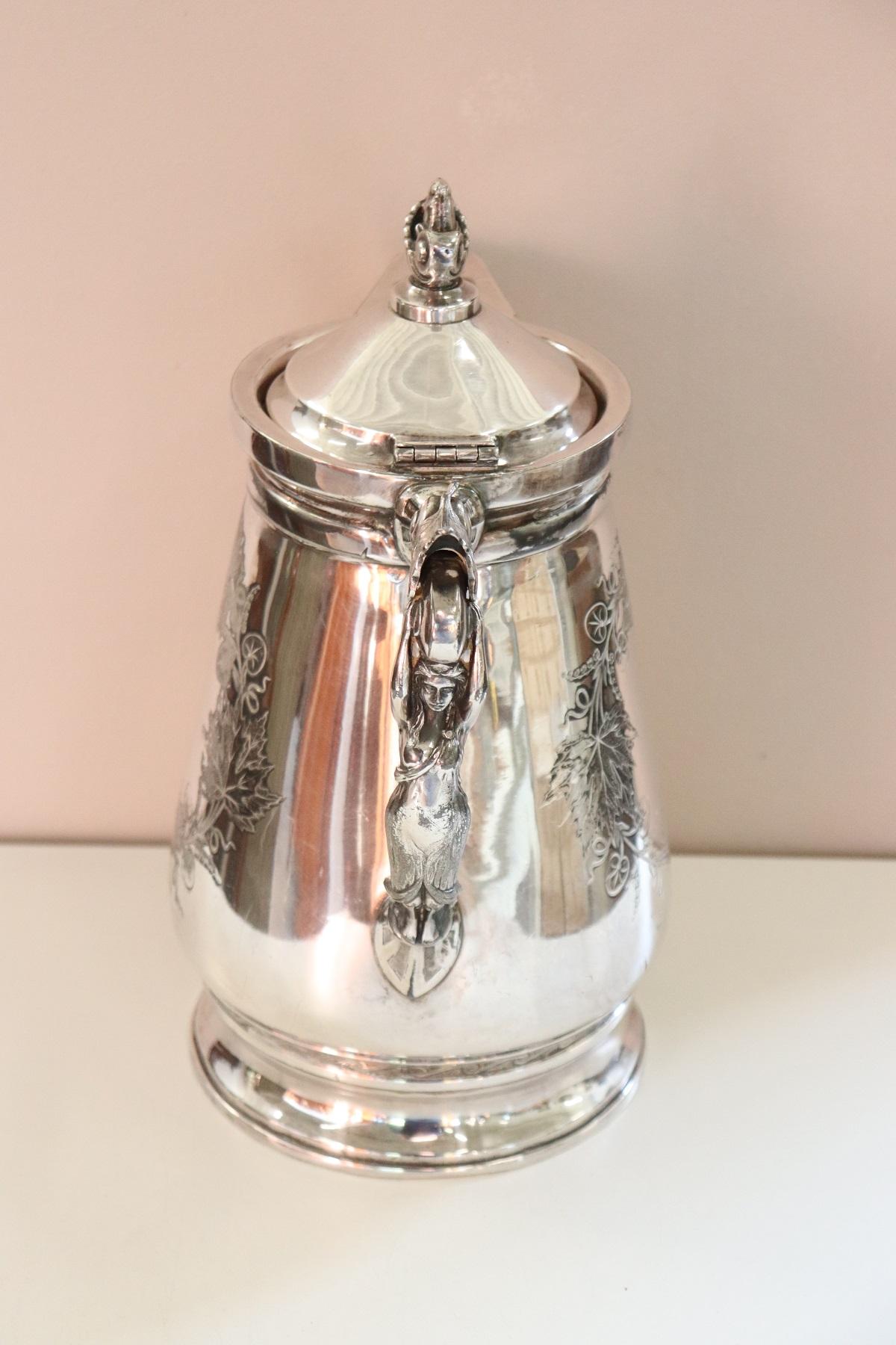Beautiful American antique silver plate pitcher by Wilcox silver plate Co. Great chiseling work in the metal look carefully at the refined decoration. The handle is shaped like a woman. The body of the pot was engraved with various floral motifs. on