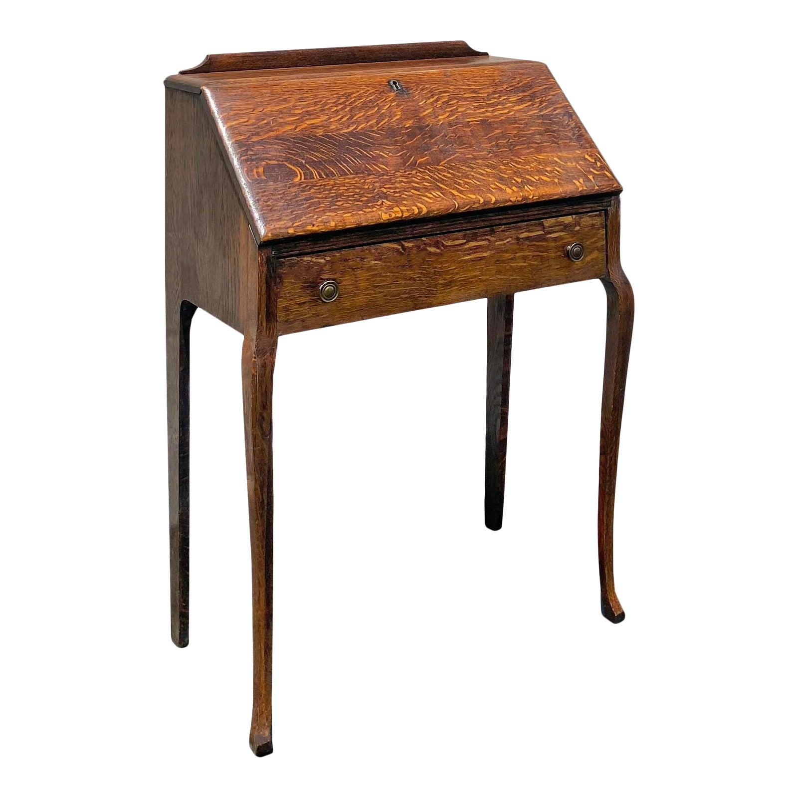 A beautiful well-maintained late 19th century American antique writing desk with a pull down table top, that unfolds to a desktop with a petite pull out drawer and wood dividers. A larger drawer is positioned at the bottom. Height with the little