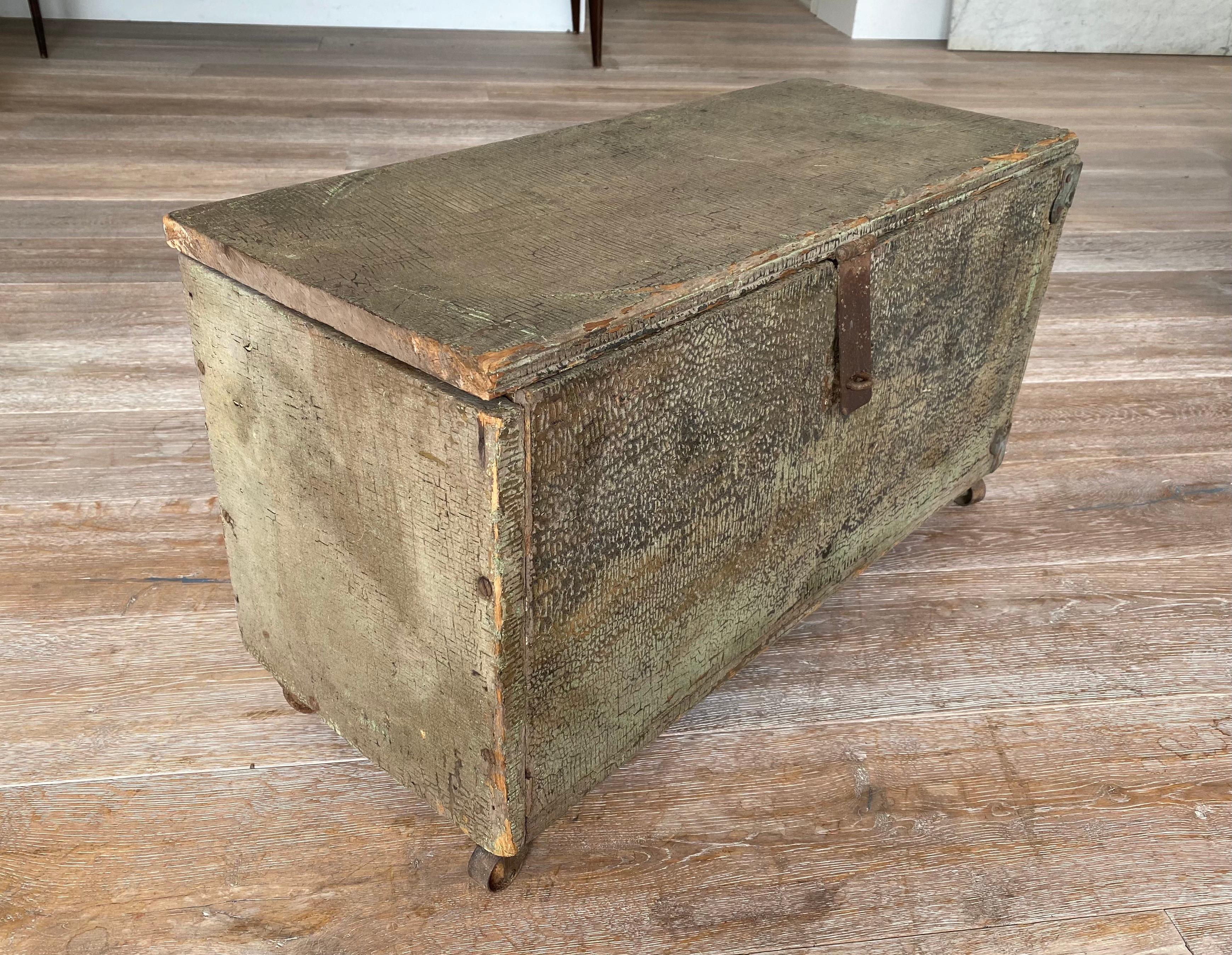 A late 19th century American lidded box with iron hardware and castors. Amazing original crackled patina to finish.