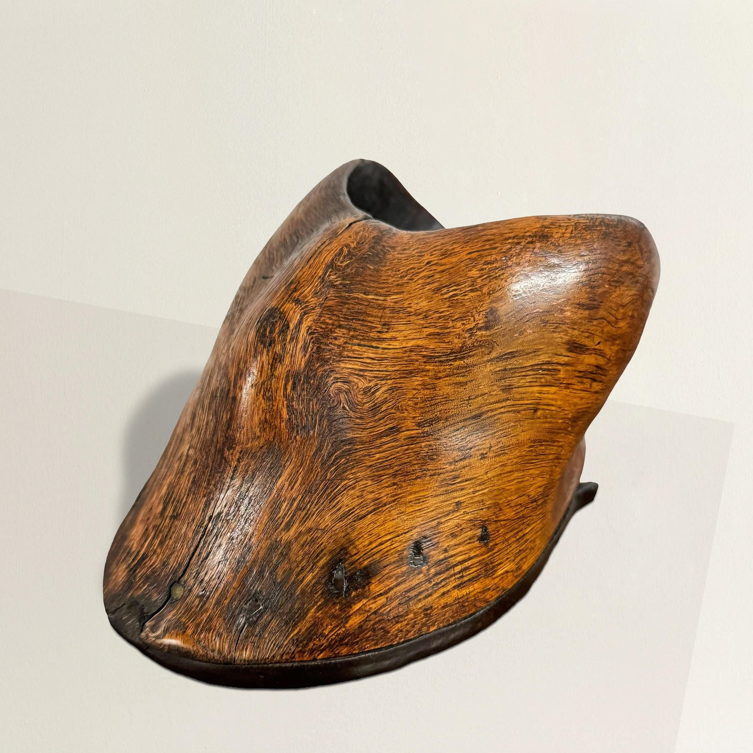 This remarkable 19th-century American Folk Art vessel, expertly carved from a natural burl to resemble a horse's hoof, is a quintessential example of Folk Art's imaginative and unconventional spirit. The meticulous attention to detail is evident in