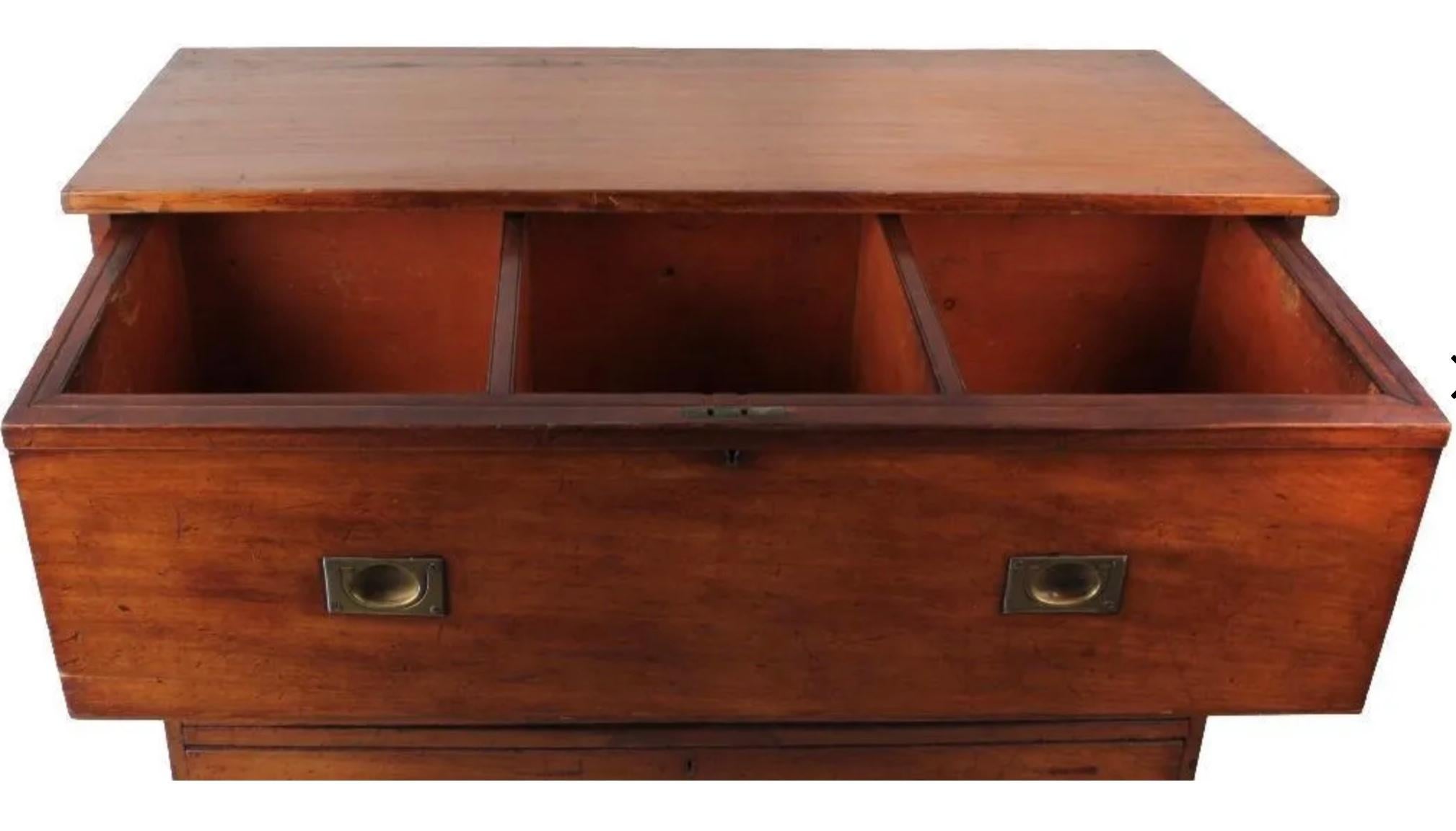19th century campaign chest. Rectangular surface over three full length drawers with brass backed pulls. With an oval makers brand 