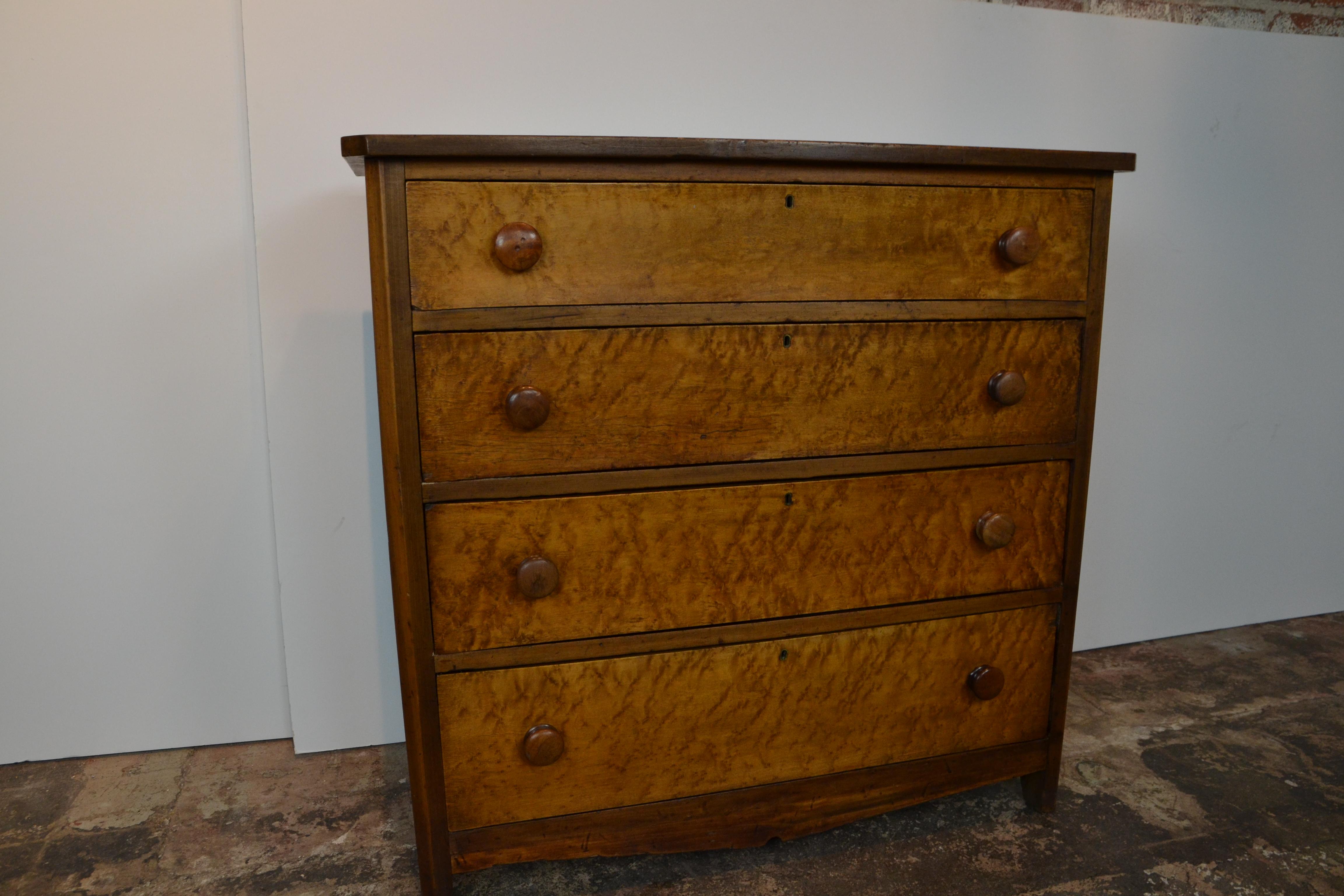 A 19th century chest of 4 drawers in cherrywood with maple drawer fronts.