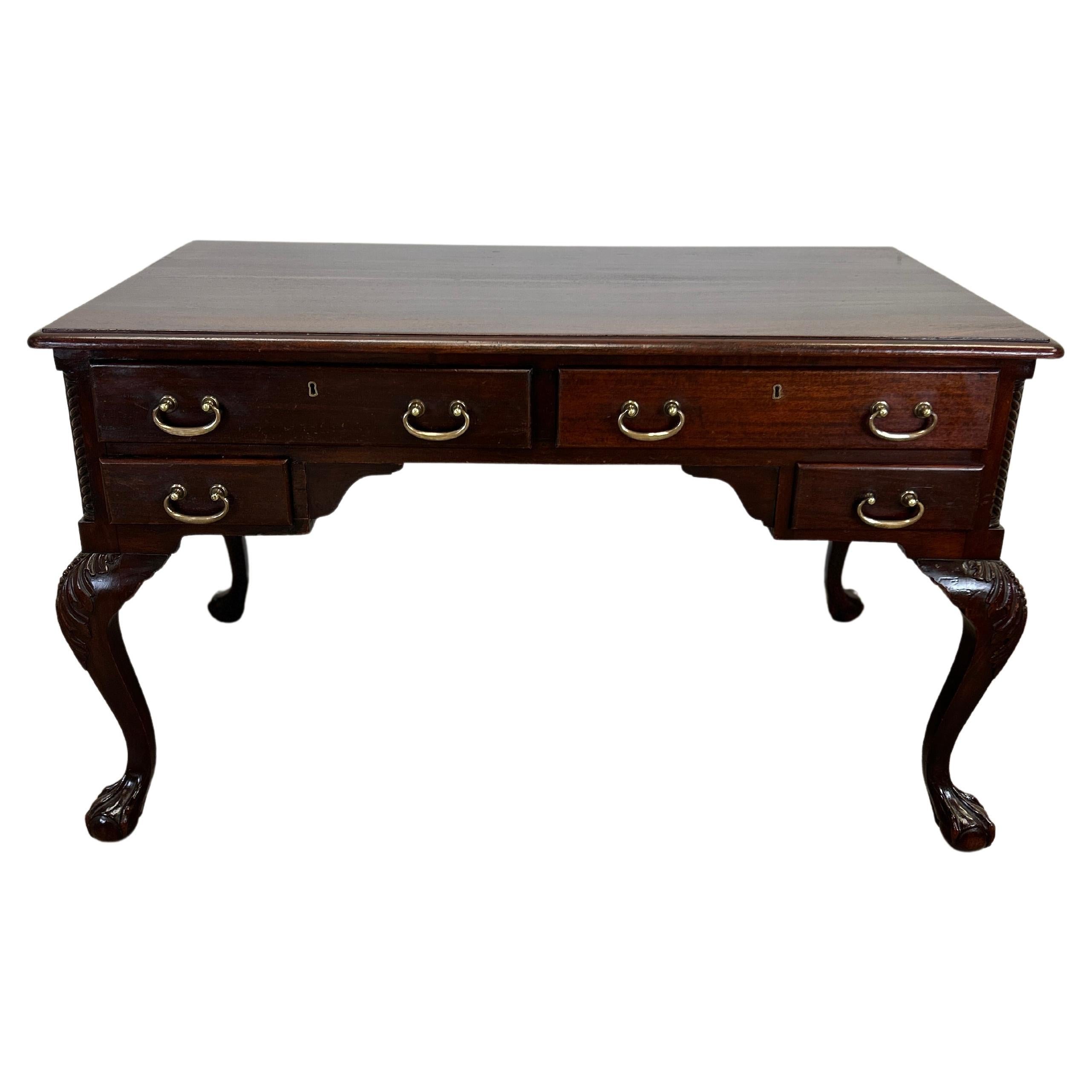 This 19th century American chippendale desk is a true masterpiece that will make a statement in any home or office. Made from solid mahogany, this desk features exquisite brass pulls and cabriolet legs with claw on ball feet, showcasing the