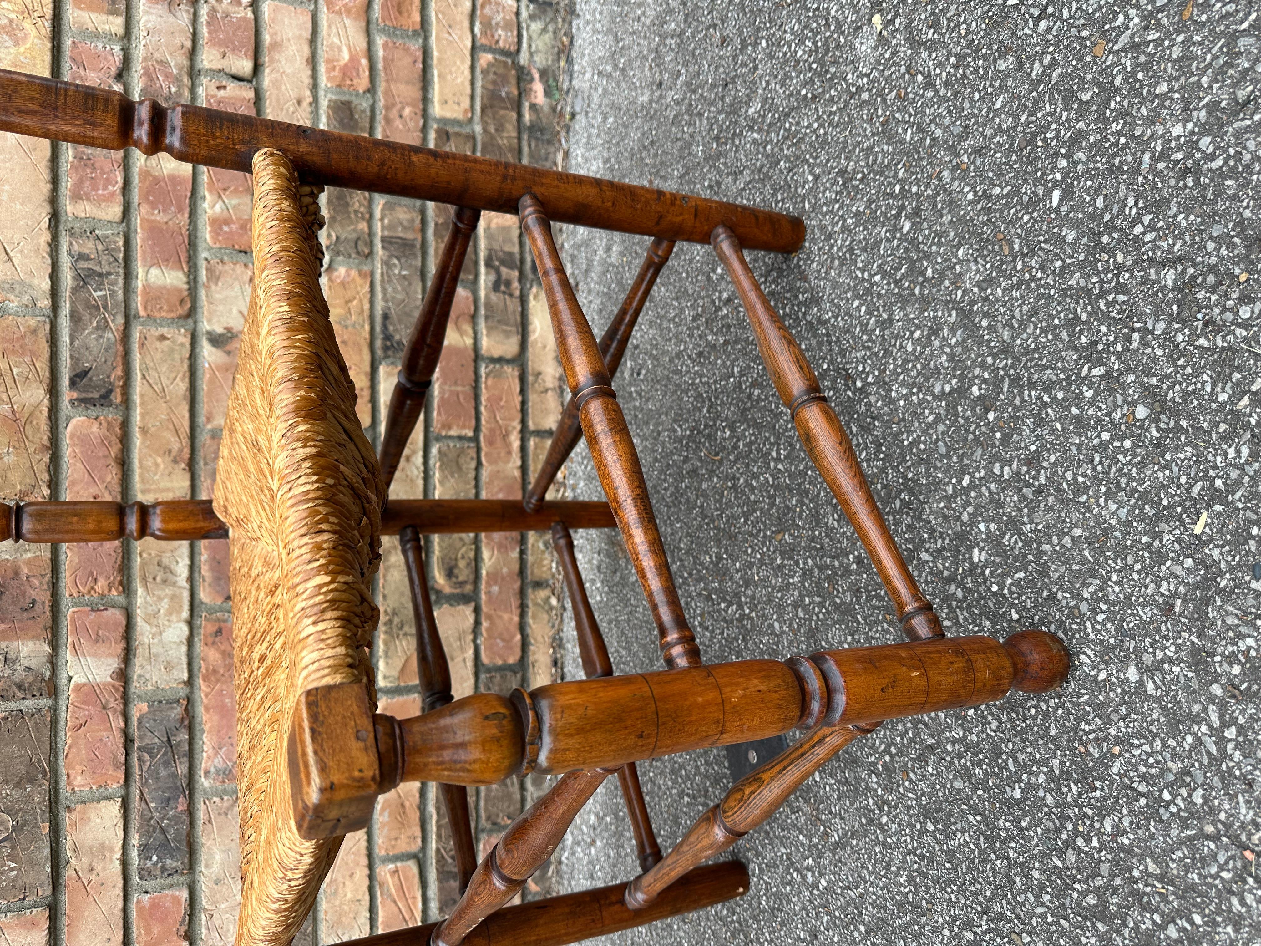 This 19th century corner chair is an example of early American craftsmanship probably from the upper East Coast somewhere. Beautifully shaped back and arms . The wood shows beautiful patina and age along with a rush seat that has probably has been