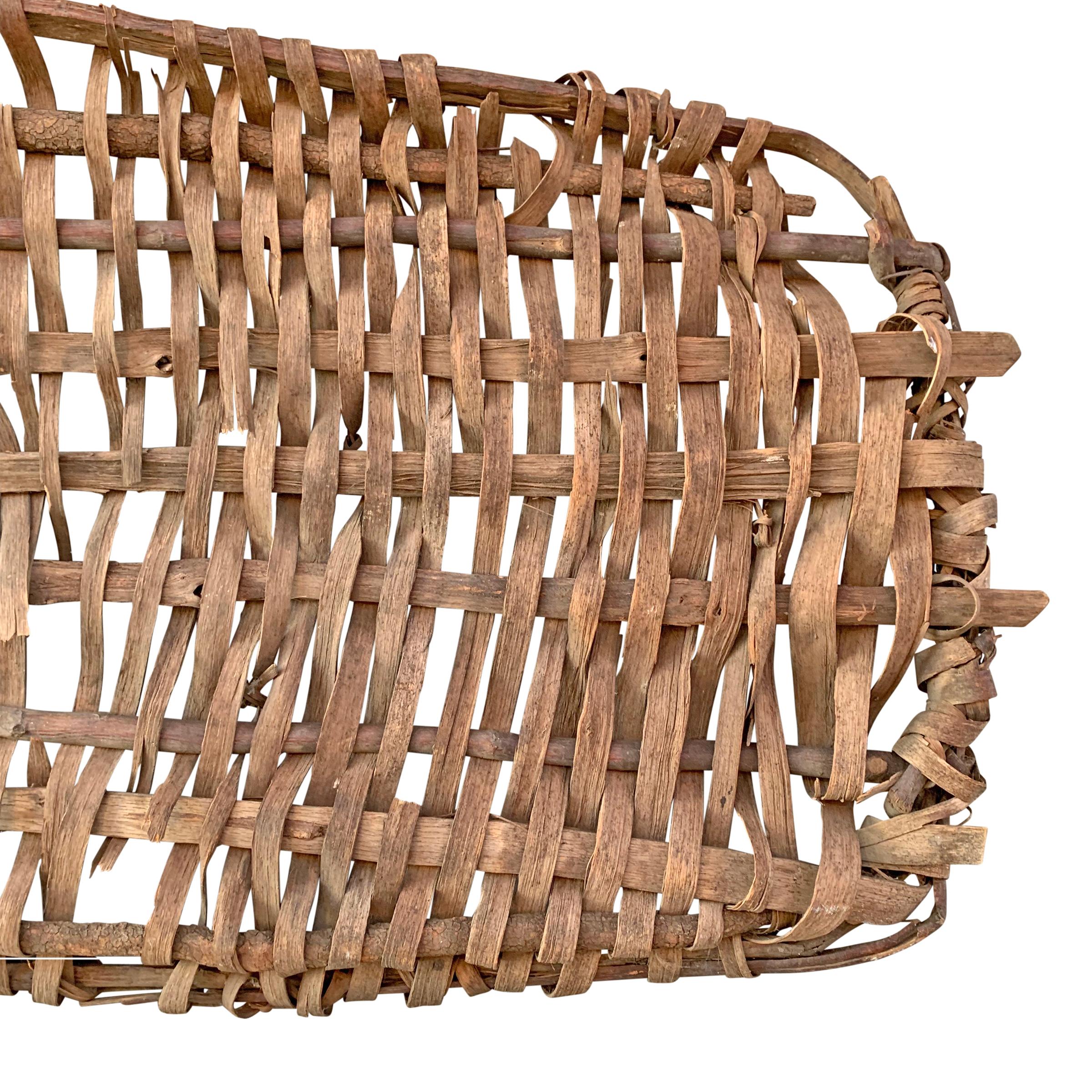 A wonderfully sculptural 19th century American drying basket probably used to dry herbs, leaves, fish, or other meats, constructed with a thick bent oak frame and thinner oak splints. Perfect as a wall hanging; can be hung horizontally or vertically.