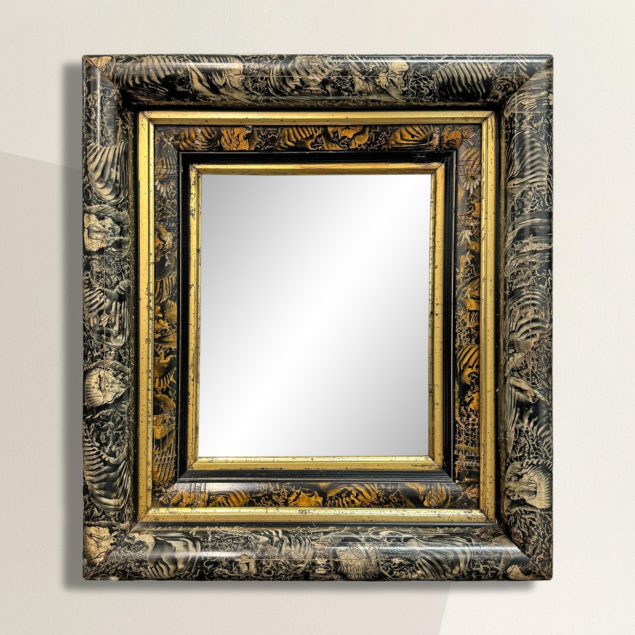 This 19th-century American Eastlake framed mirror is a rare and remarkable find, showcasing the intricate craftsmanship of the era with its petite floral carved and gold leafed details. What truly sets it apart, however, is its most unusual two-tone