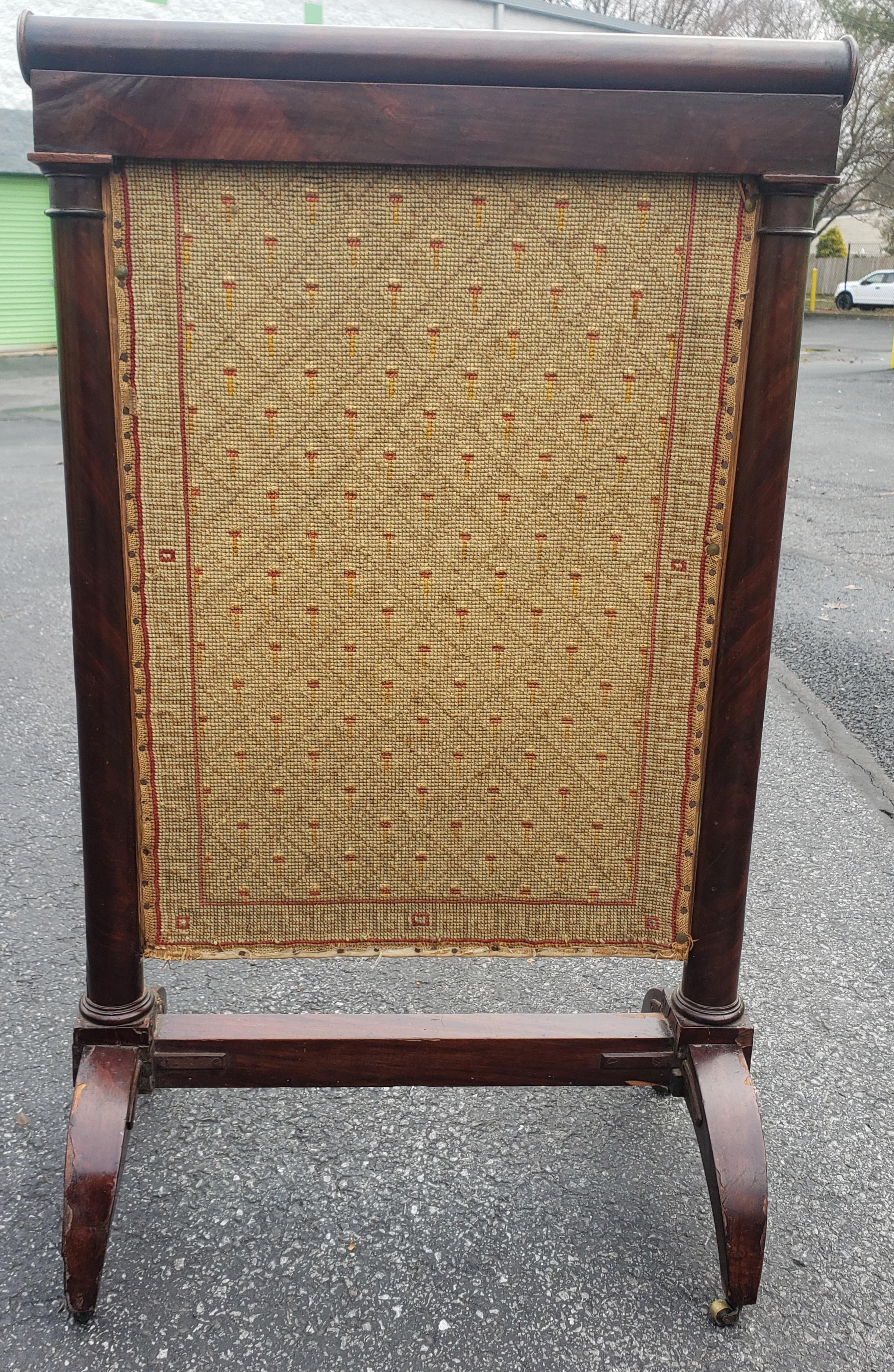 19th century American Empire Mahogany and needlepoint fireplace screen on wheels.
Measures 22