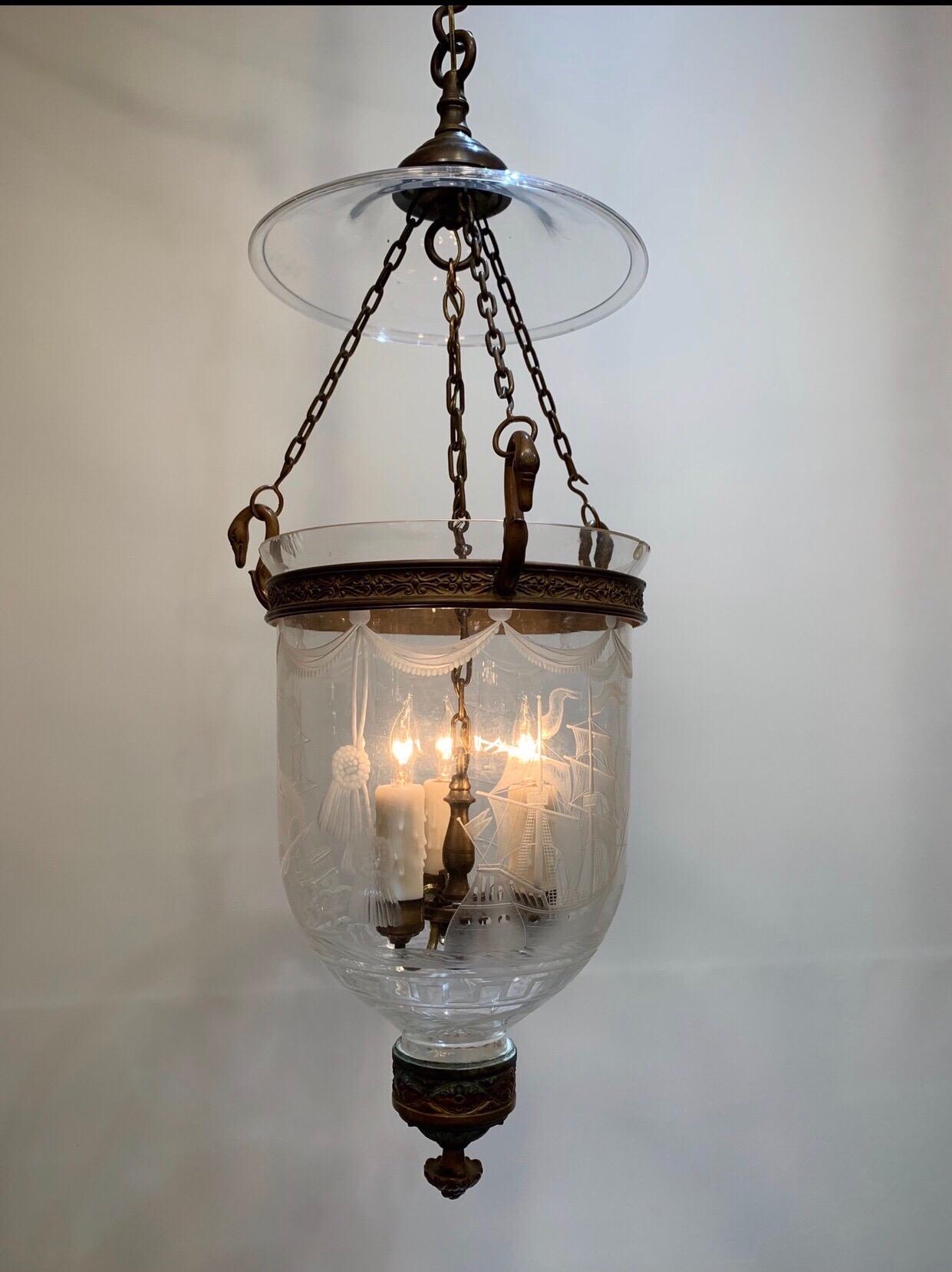 Rare 19th century American etched bell jar lantern with ships. This Classic Federal bell jar has an etched theatrical drape border around the top with double tassels hanging between the full-rigged brig ship floating on ocean waves above a Greek key