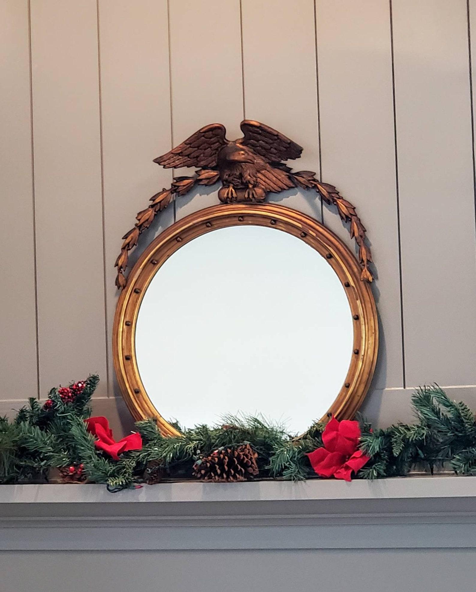 A stunning and rare antique American Federal giltwood wall mirror dating to the first half of the 19th century. The fine quality example surmounted by a large carved figural eagle crest, richly detailed, sculptural form, head protruding out and