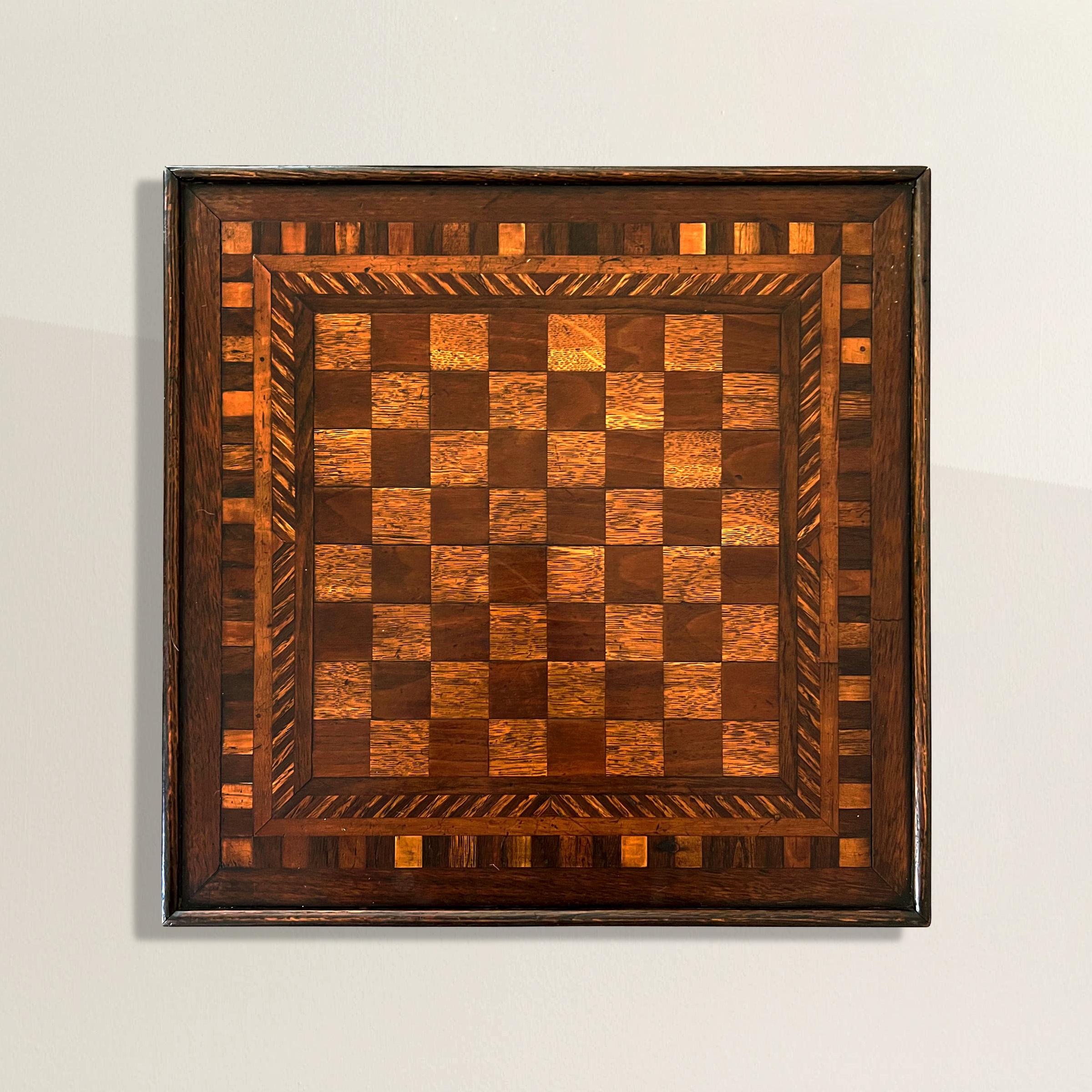 Transport yourself to the enchanting world of traditional American folk art with this 19th-century game board, a true embodiment of the cherished folk art game board tradition. Crafted with a charming combination of oak and mahogany, this