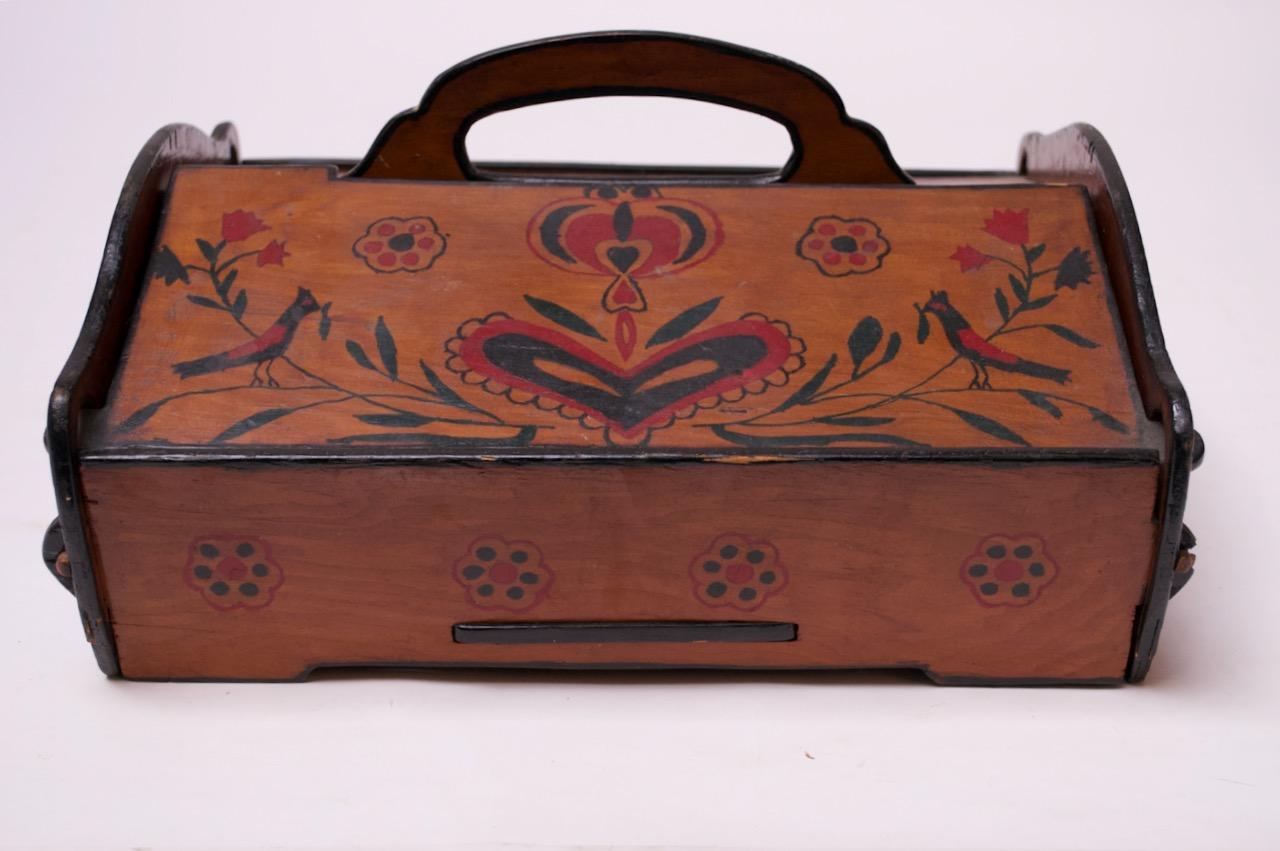 19th century American carved poplar sewing / jewelry box with hand painted floral, leaf, and bird decoration throughout. Spots, scratches and edge fissures / loss of veneer to the corners (expected wear for its age). There is also a split in the