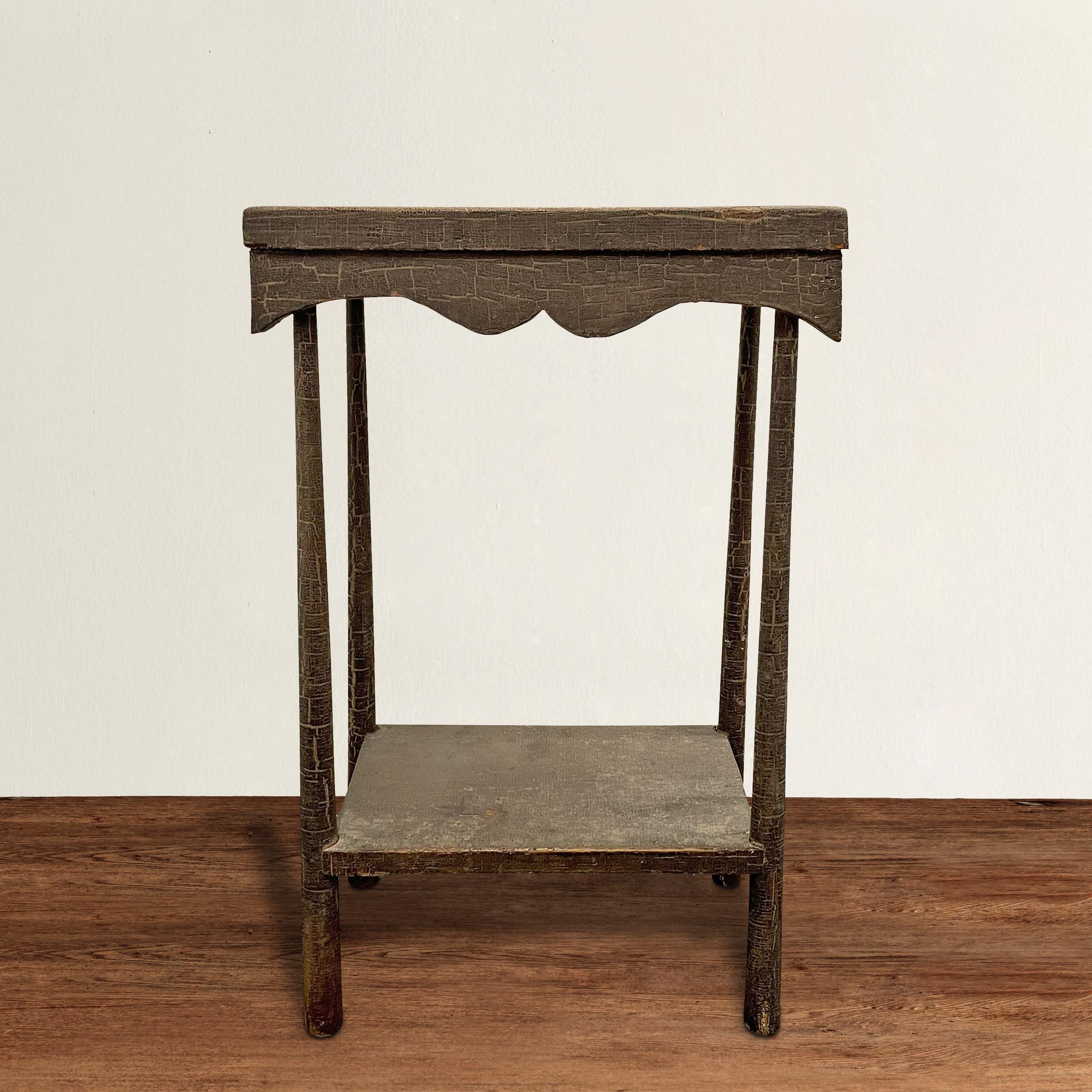 A wonderfully charming and full-of-personality 19th century American Folk Art side table constructed from parts of other tables over one years ago, and with a scalloped apron, slender tapered legs, a shelf, and the most beautiful paint with an