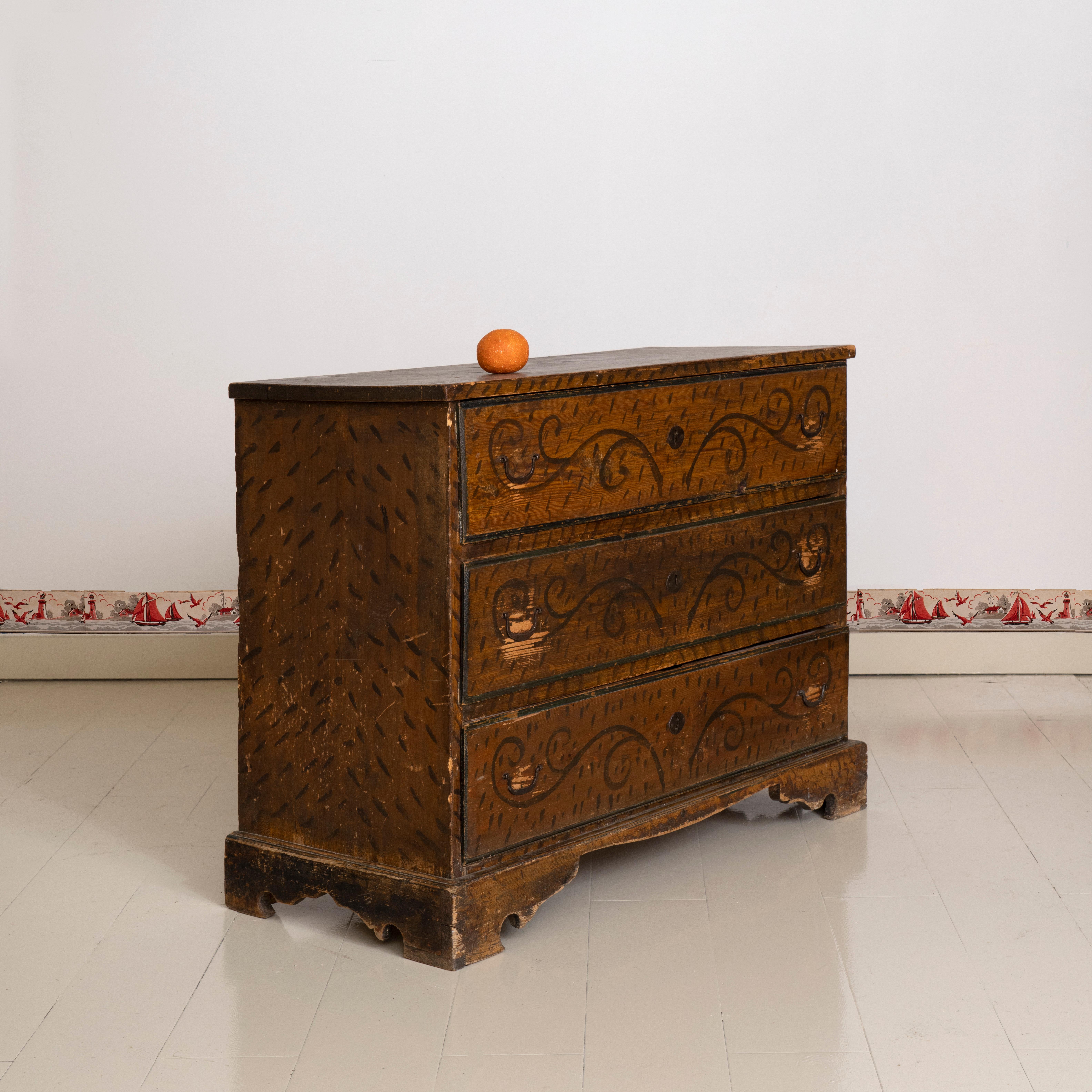 19th century American folk painted chest of drawers. Hand painted on sides and front with dark brown swirling patterns and dashes. A rustic and authentic example of American folk design.