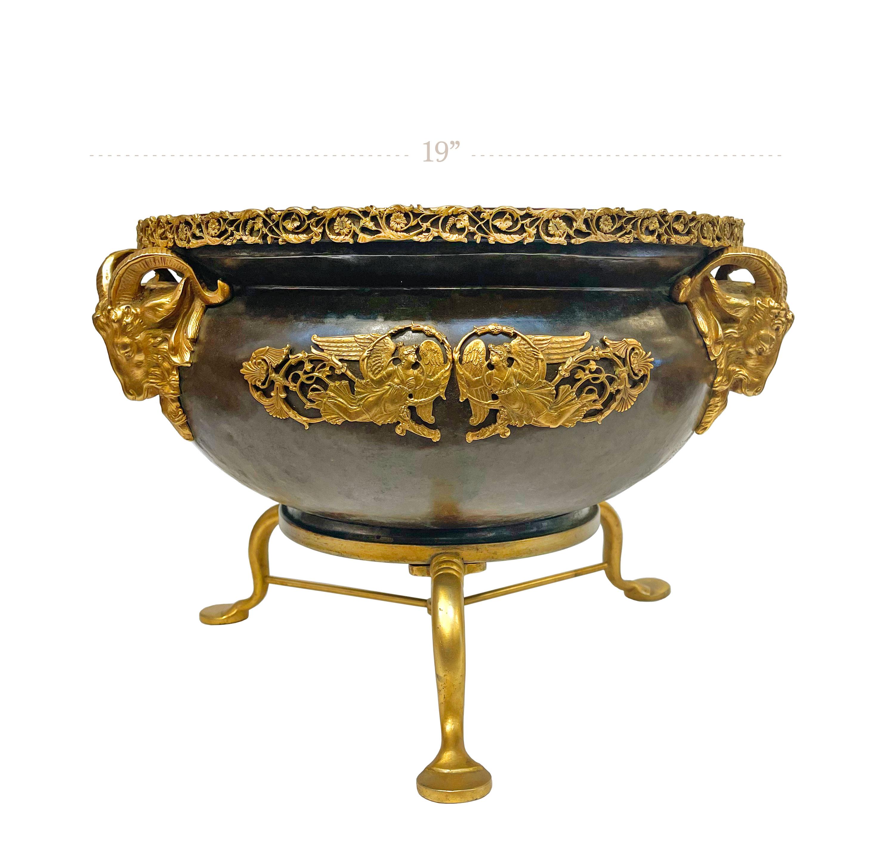 An American gilt & patinated bronze Jardiniere. with rams masks handles. Attributed to Edward F. Caldwell & Co.

Measures: D: 19