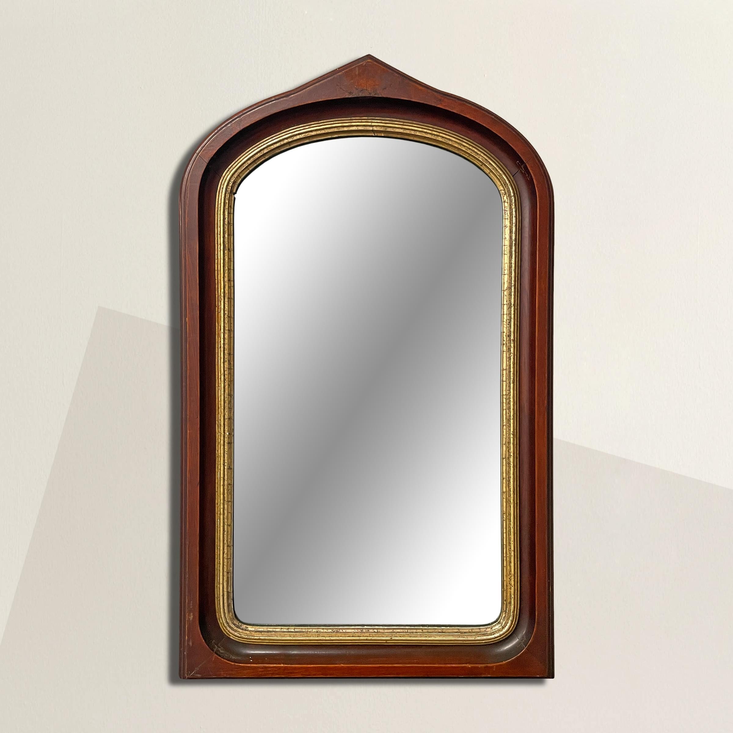 A stunning 19th century American Gothic Revival mahogany framed mirror with a pointed arched top, and gold leaf fillet surrounding the original mirror. Perfect in a powder room, above the table in your entry, or as the focal point above your mantel.