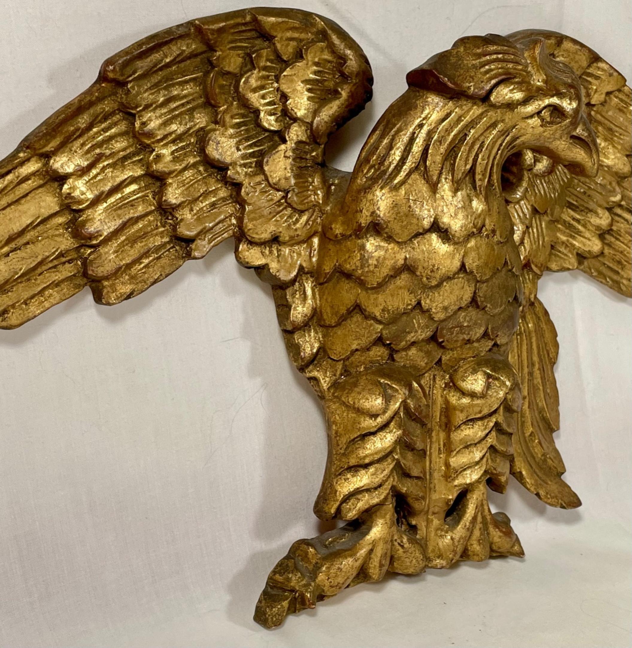 aigle américain à fronton doré, sculpté à la main, du 19e siècle.

Aigle décoratif ancien à fronton en bois sculpté et doré à la main. La sculpture expressive avec la tête tournée vers la gauche et les ailes déployées est exécutée de façon