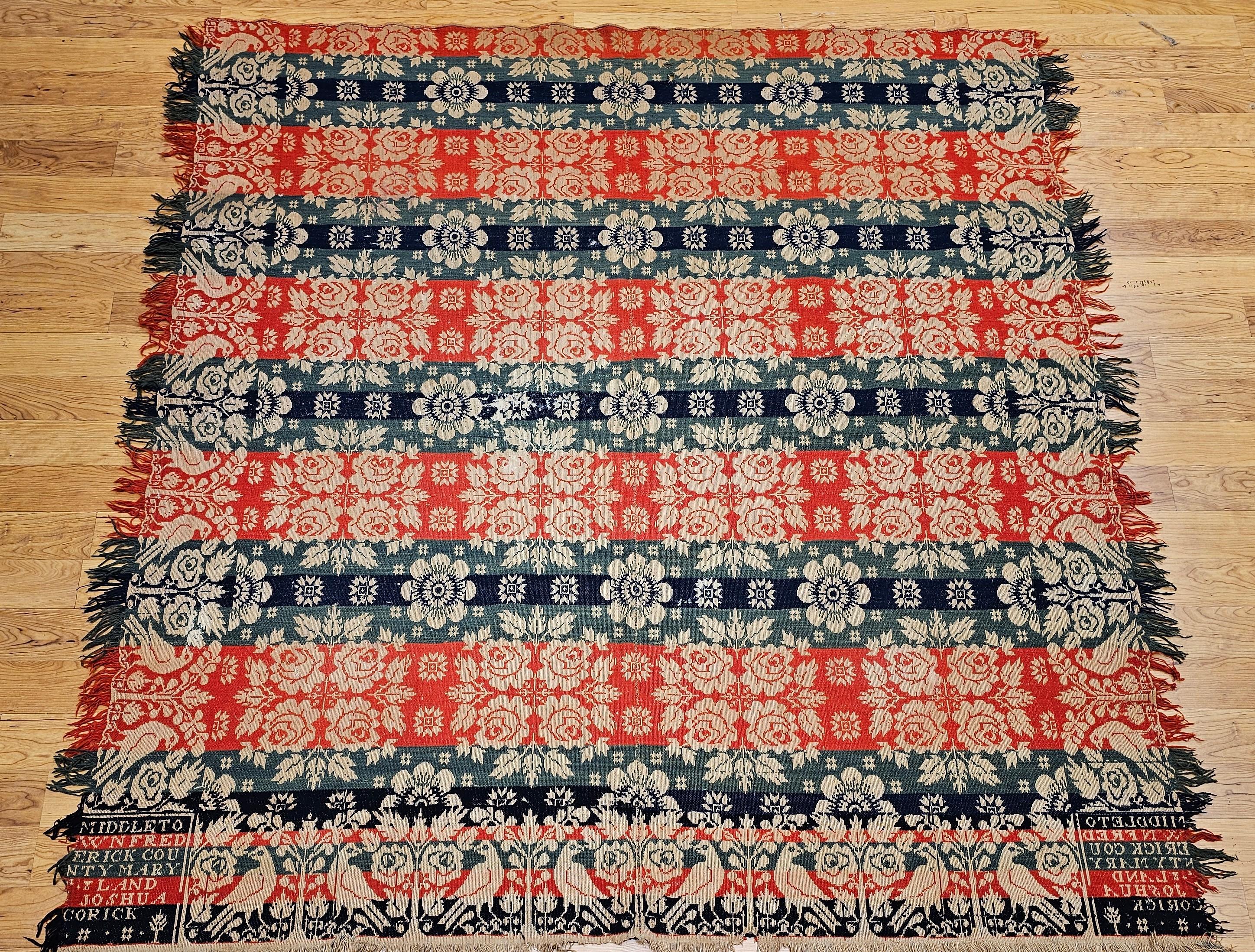 This exceptionally rare Jacquard-woven American coverlet from 1841 is a true collector’s gem, signed by the weaver Joshua Corick of Frederick County, Maryland. Woven in rich red, blue, green, and ivory, the coverlet features a bold and patriotic