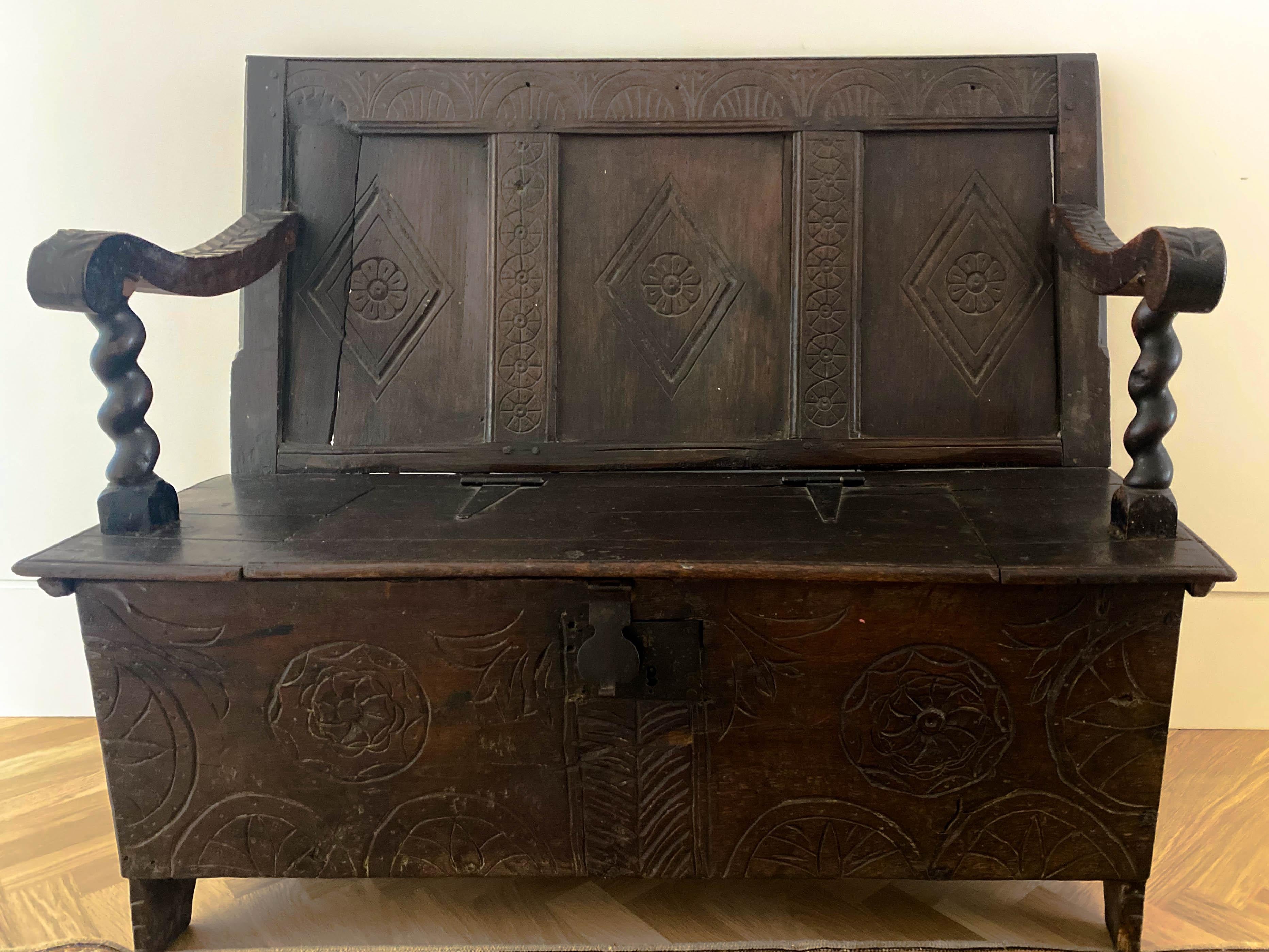 19th century American long wooden bench in ebonized black features hand-carved wood back and. Meticulous storage under seat.