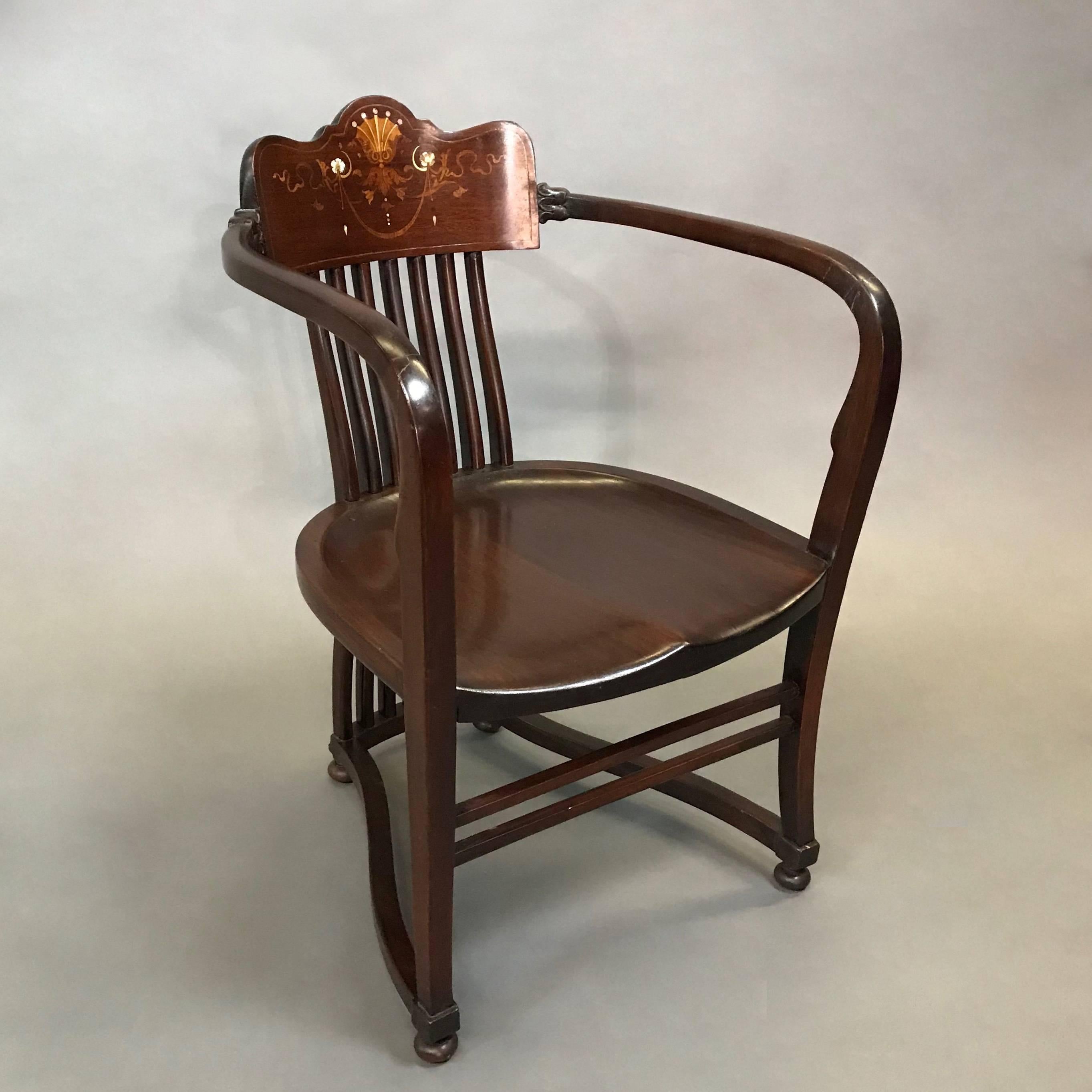 Wonderful, antique, mahogany armchair circa 1860s features a spindle back, wide arms and decorative mother-of-pearl and boxwood inlay detail on the back rest.