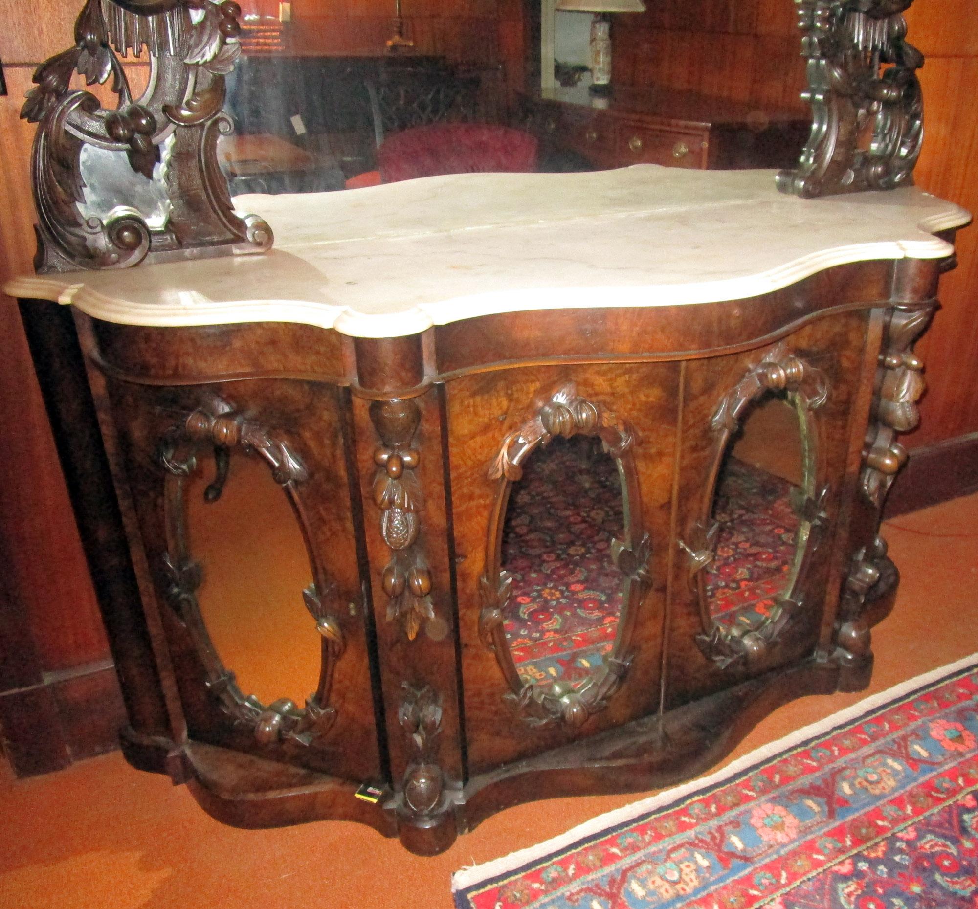 Truly one of a kind and right out of a Southern antebellum home, this monumental sized mahogany sideboard features all the bells and whistles of the Rococo Revival furniture period. Attributed to J.H. Belter, a New York cabinet maker, taste for his