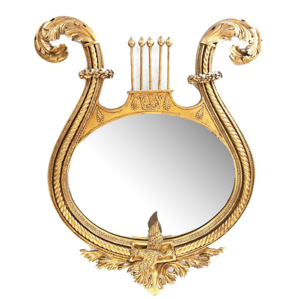 19th century gilt wood oval mirror with lyre-form frame. In good condition as with age.