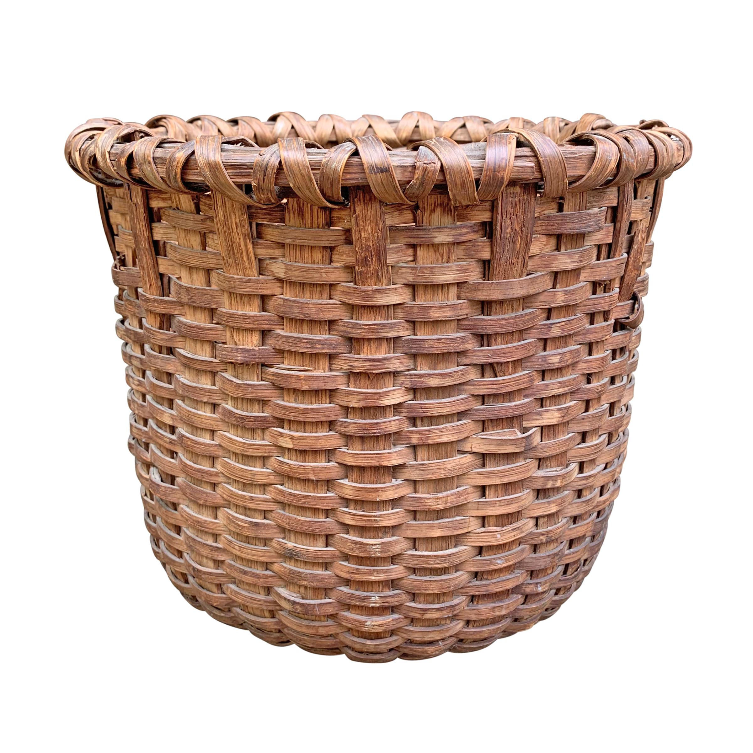 A beautiful 19th century American gathering basket tightly woven with thin oak splints, a double-banded rim, and wonderful patina.