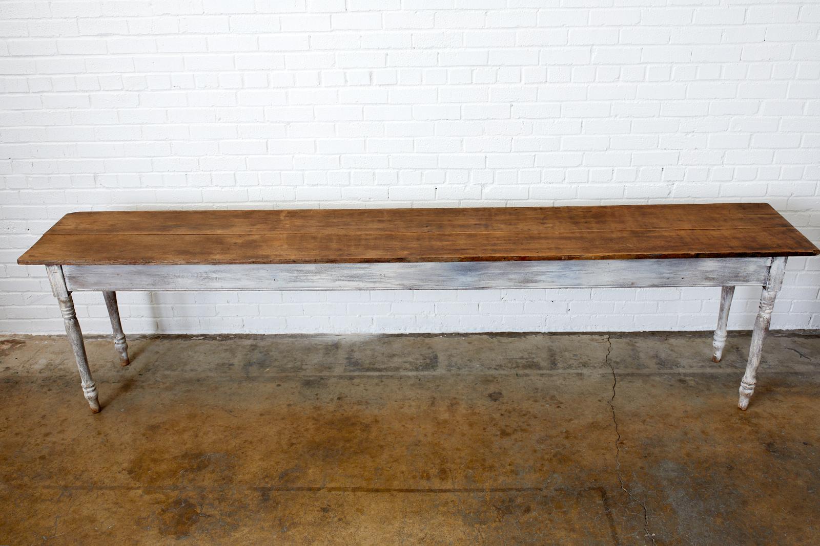 Rustic 19th century American farmhouse harvest table, work table, display table, dining table, or console. Features a natural plank top over 10 feet long. Supported by a painted base with classic turned legs. Excellent joinery and craftsmanship with