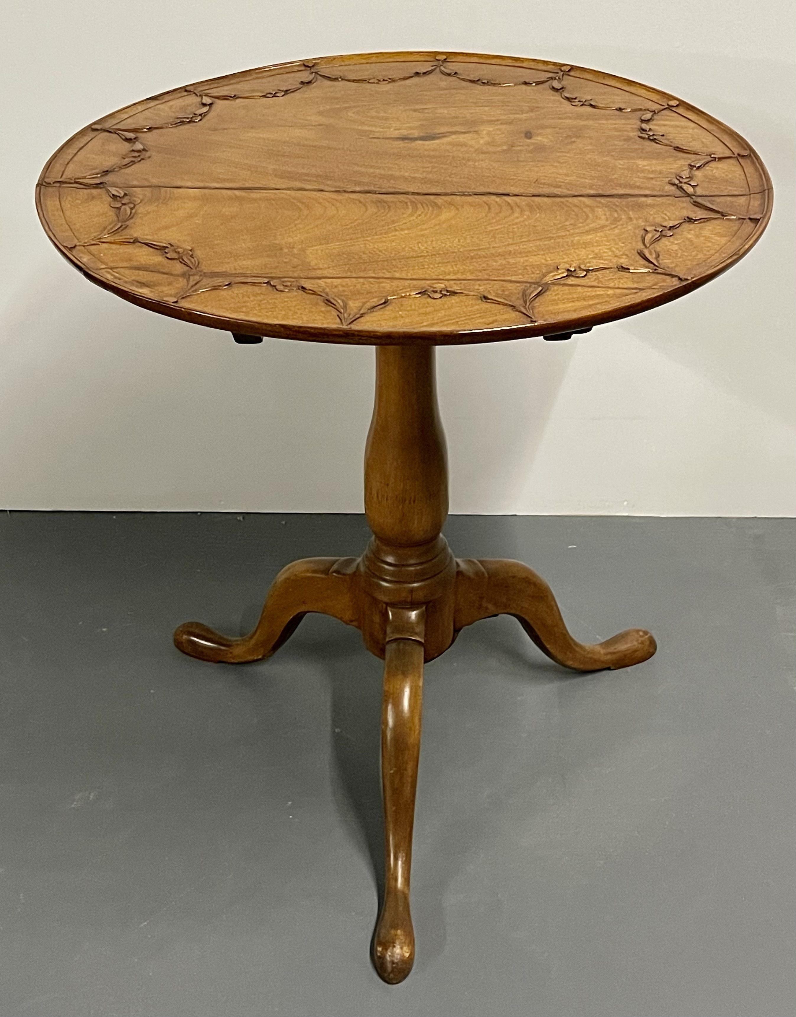 A fine 19th century pie crust tilt top table having solid wood carved construction in the Queen Anne Style. Age split across the top of the table.