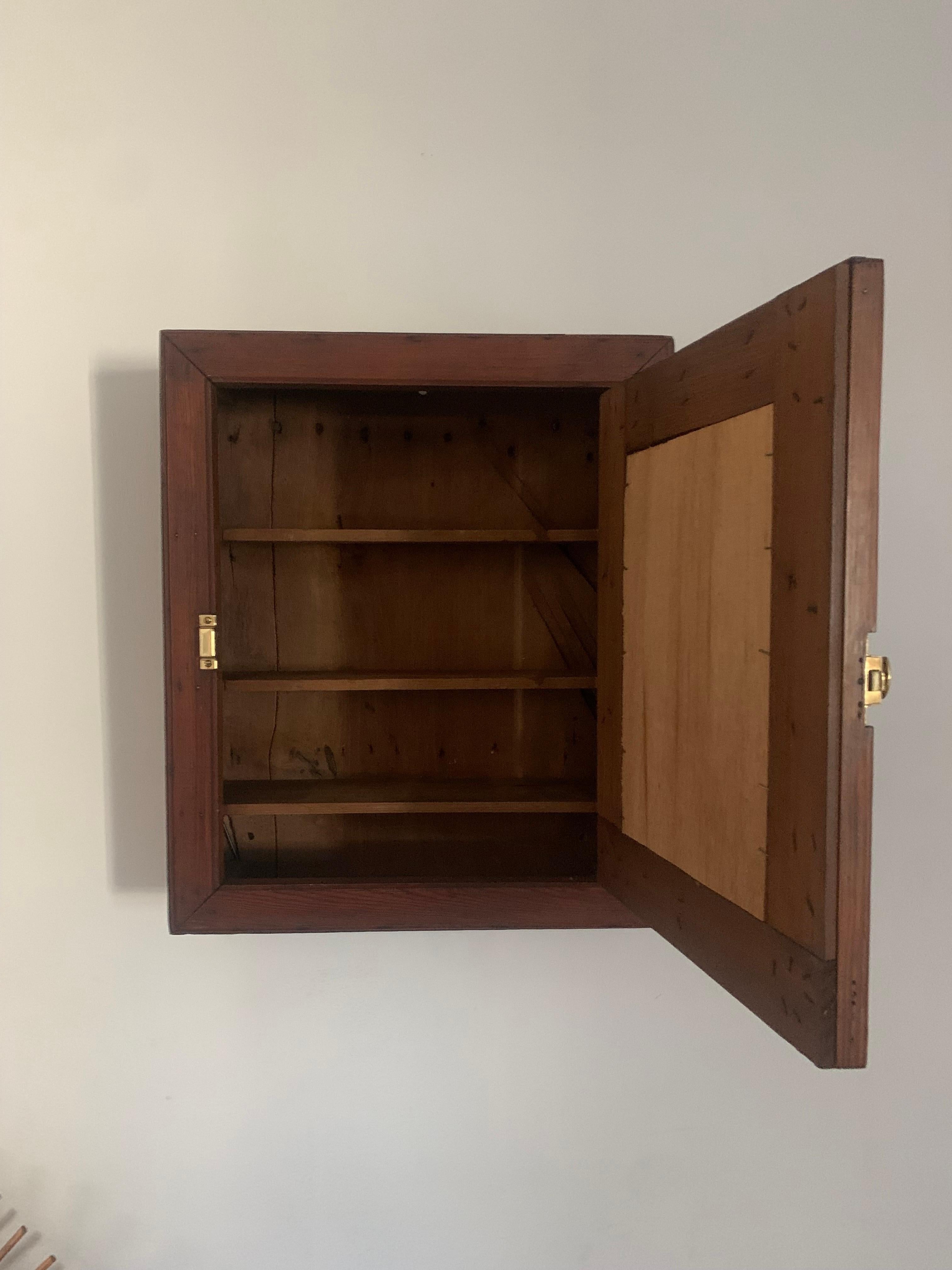 Antique 19th century pine medicine cabinet. Solid construction of thick old growth pine wood. 

At some point in its long life it was refinished however that finish has aged beautifully. 

Tasteful patina throughout and retains a solid structure.