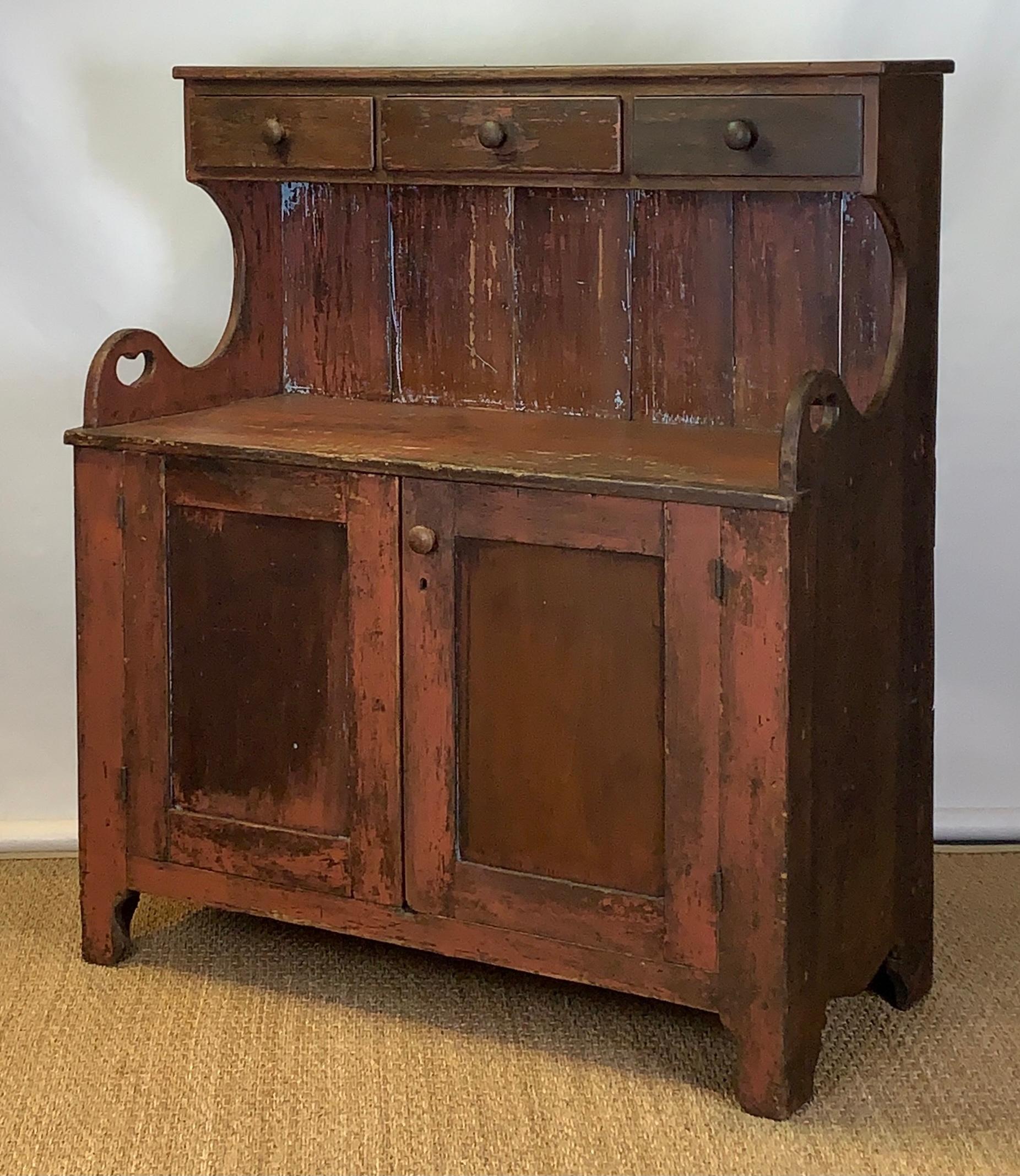 A very charming mid-19th century. American paint decorated dry sink or cabinet retaining traces of original paint likely from the Mid-Atlantic region.