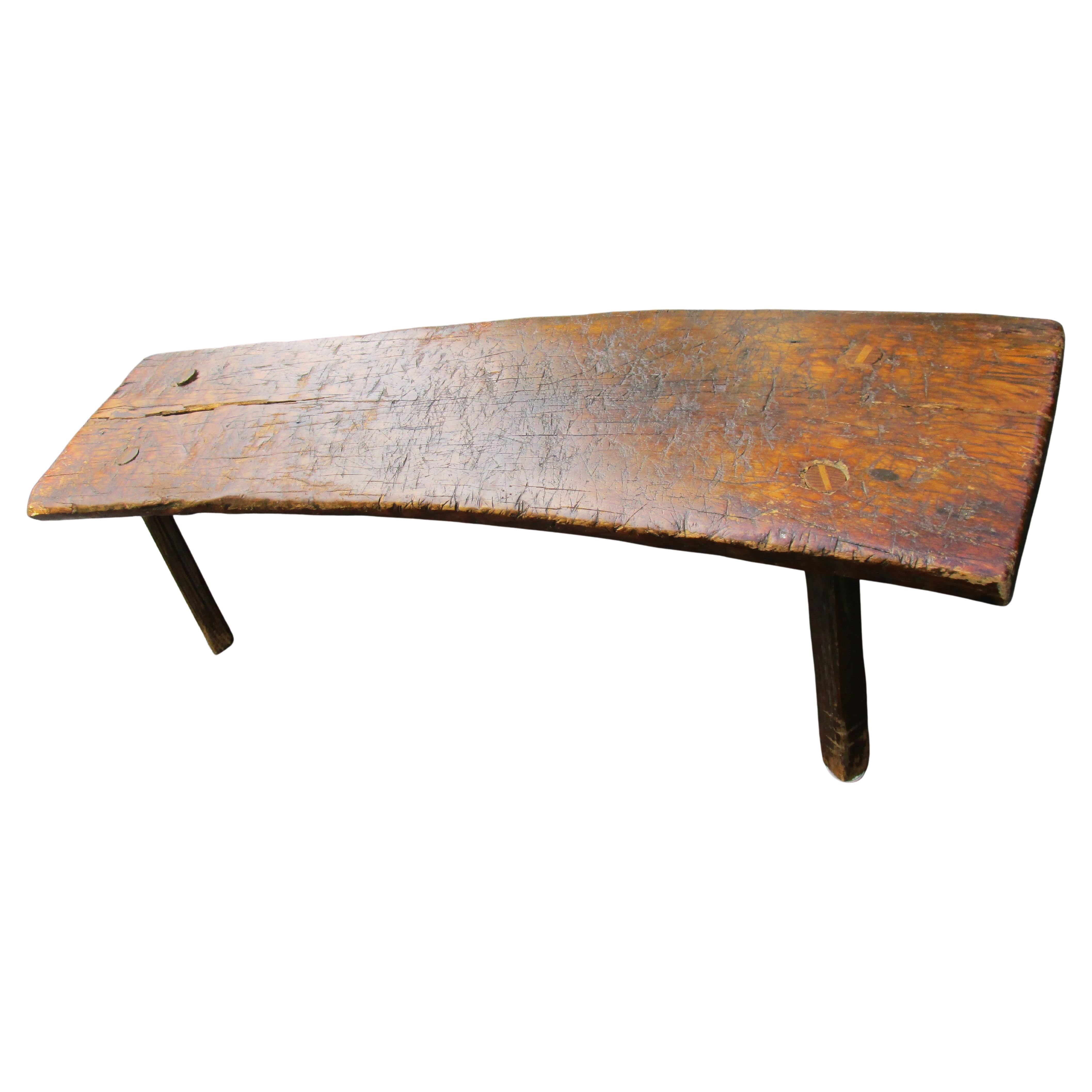 Antique 19th century American primitive slab bench / butchering bench w/ four hand hewn splayed pegs and 2 1/4