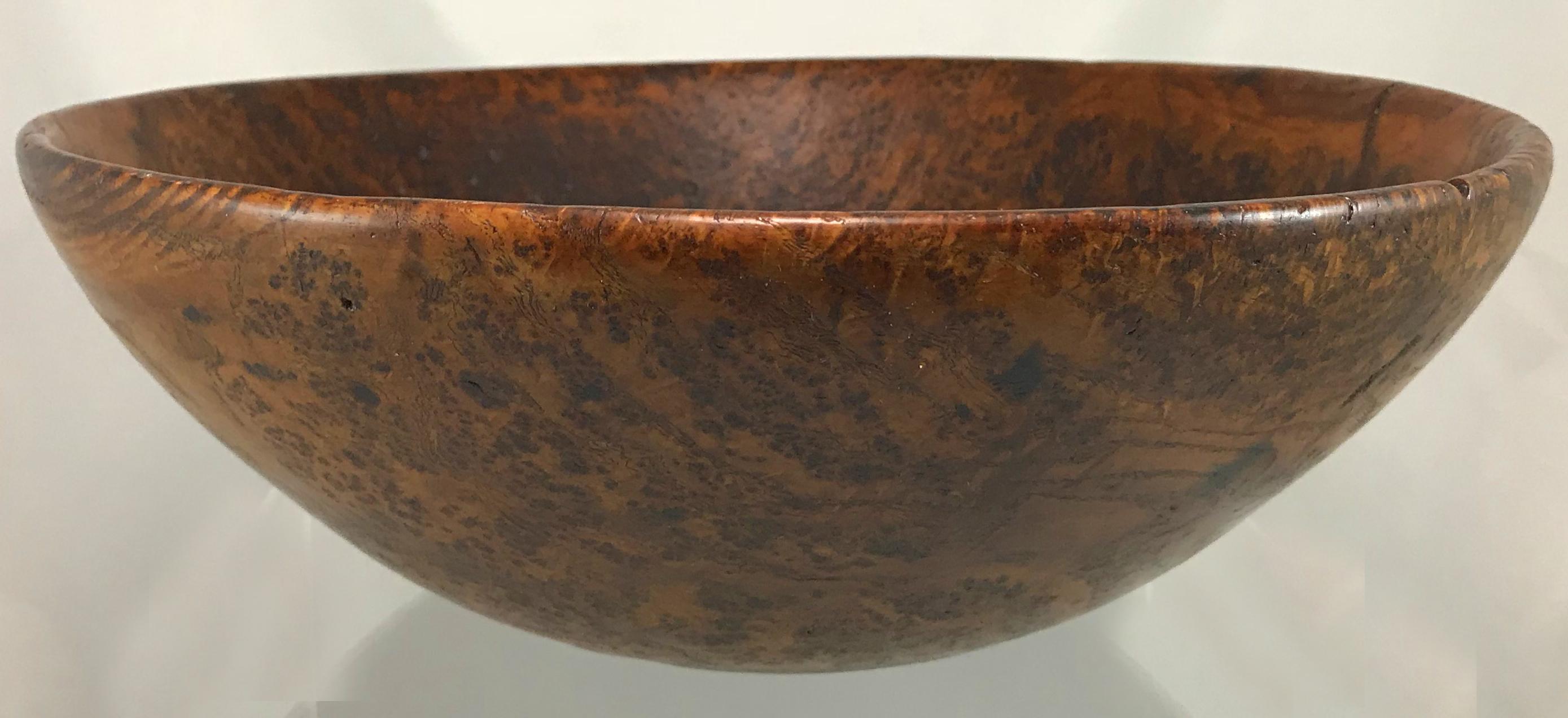 A fine example of a round burl bowl, probably American in origin dating to the 19th century with great overall patina, minor shrinkage cracks, and other minor imperfections and surface wear from age and use. A great addition to your primitives