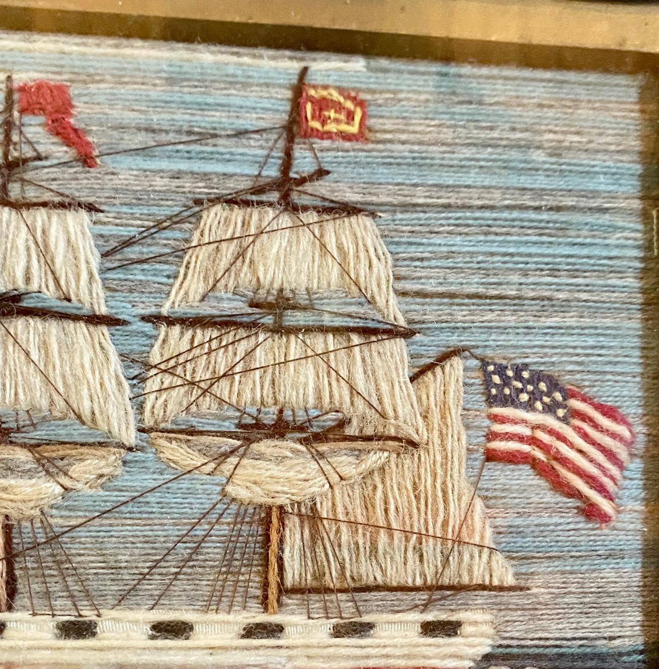 Rare 19th century American Sailor’s Woolie, second half of the 19th century, a sailor's folk art hand stitched wool yarn embroidered picture of a Brig under sail with reefed fore and main courses, two reefed head sails, flying a huge American Ensign