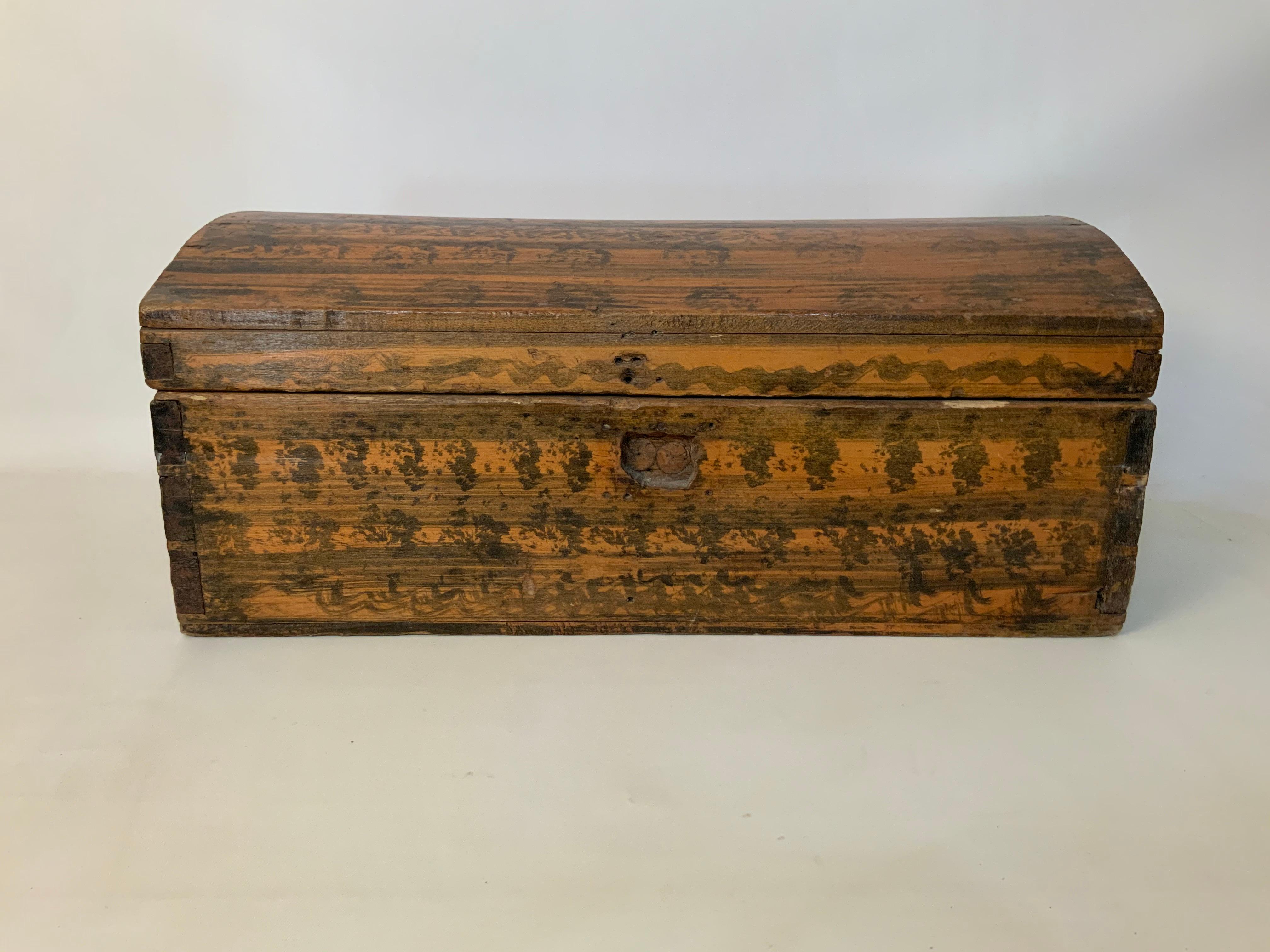 Small dome top 19th century American sponge painted and faux grained trunk. Trunks of this style often go by different names: humpback, dome top, camel back, etc. A wonderful piece of mid-19th century Americana. Pine wood substrate and decorated in