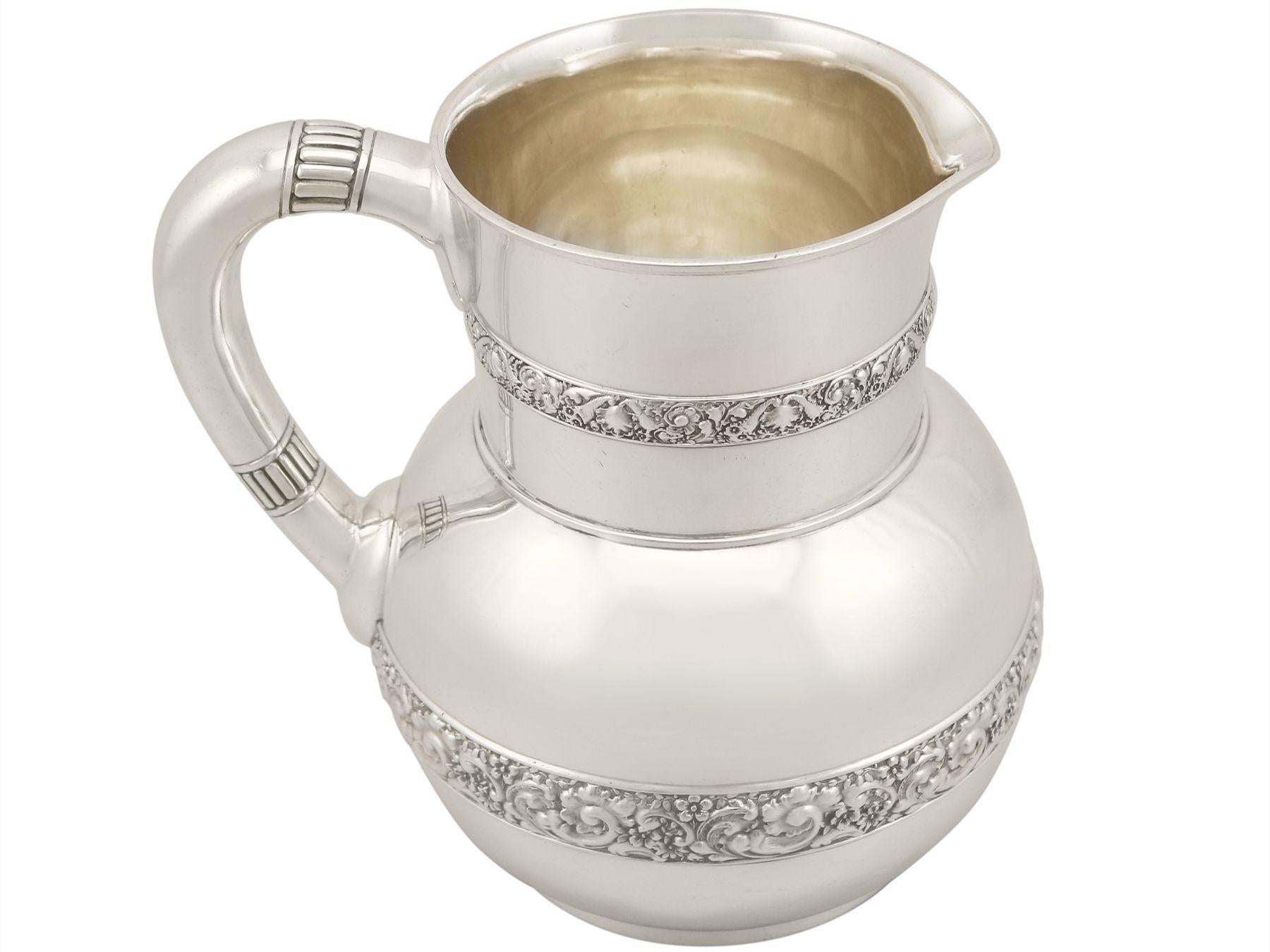 An exceptional, fine and impressive antique American sterling silver water pitcher jug made by Tiffany & Co; part of our dining silverware collection

This exceptional antique American sterling silver jug has a circular bulbous form onto a