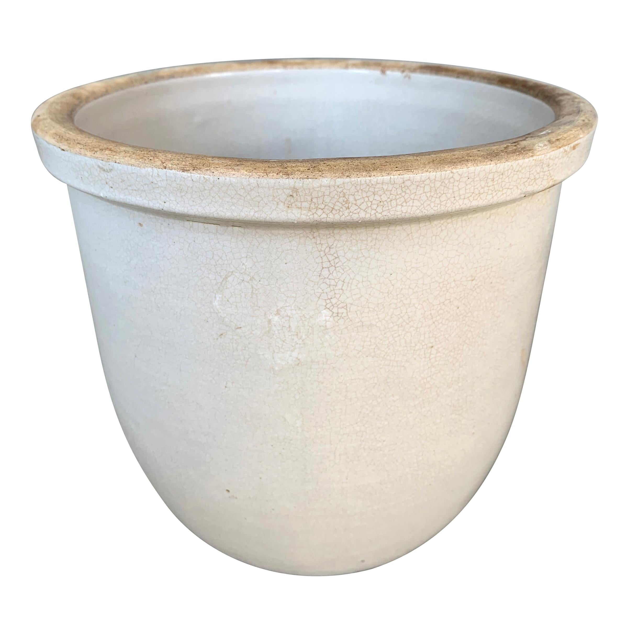 An interesting 19th century American zinc glazed pot with a thick rim, a slightly rounded base, and a wonderful crackled glaze finish. This is an excellent size for a powder room waste basket, or would make a perfect planter.