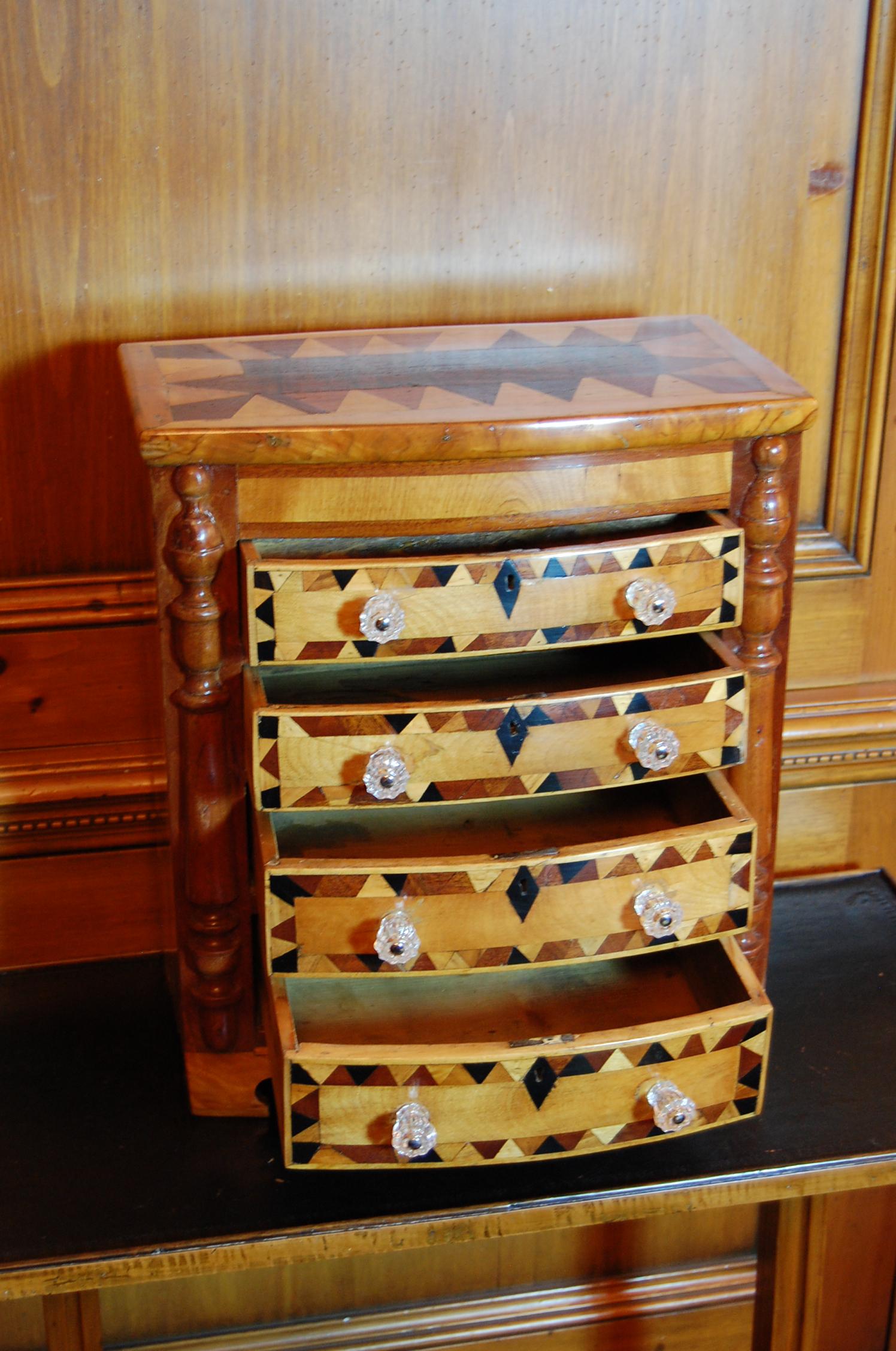 Wonderful American Tramp Art chest of drawers. Solid-end and bow fronted case fitted with four conforming drawers and parquetry inlaid. The original locks are present, but there are no keys. In a new French Polish finish.