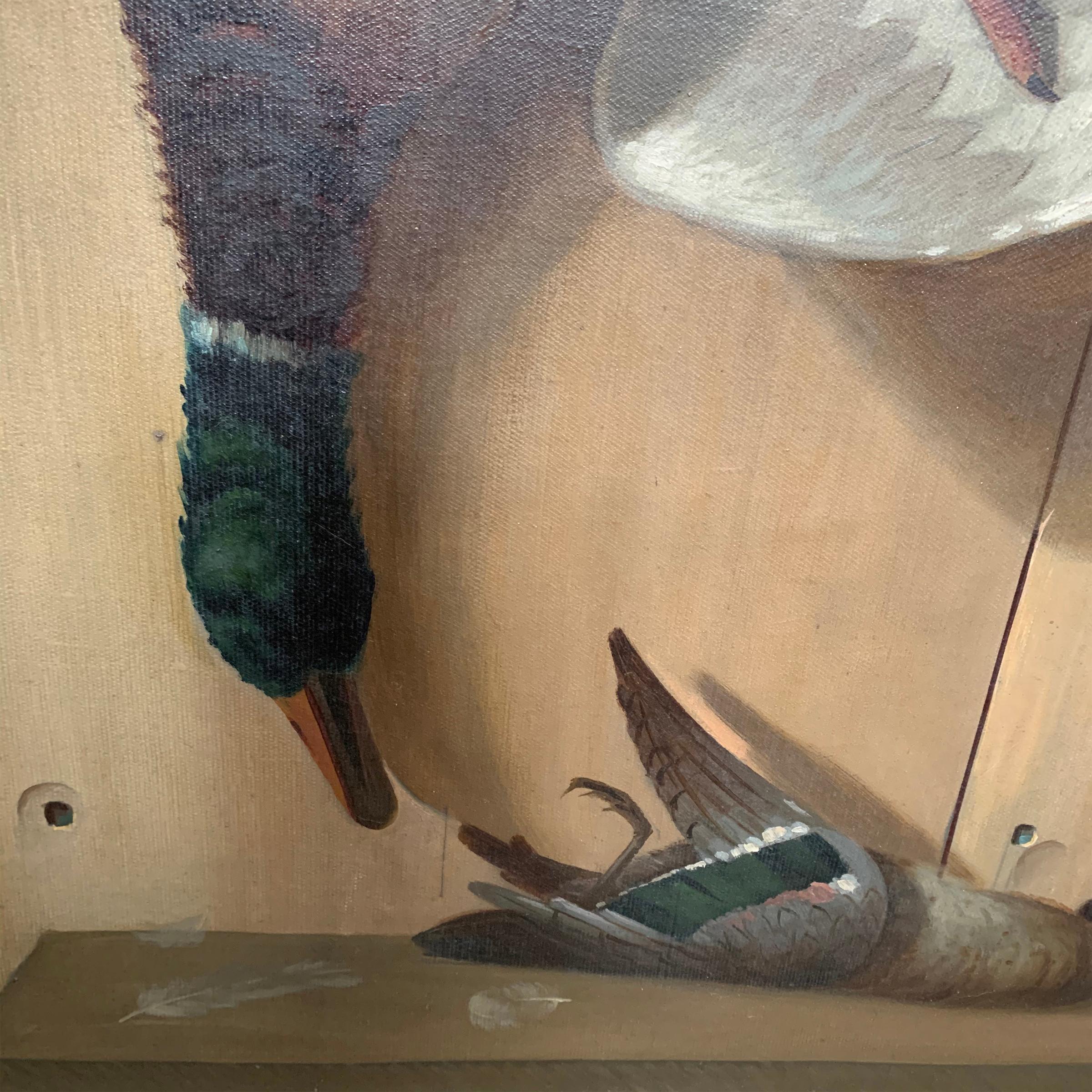 A wonderful 19th century American oil on canvas trompe l'oeil hunt painting depicting a large mallard duck hanging by a string, and a small teal duck with a few loose feathers lying on a shelf. Signed and dated, 