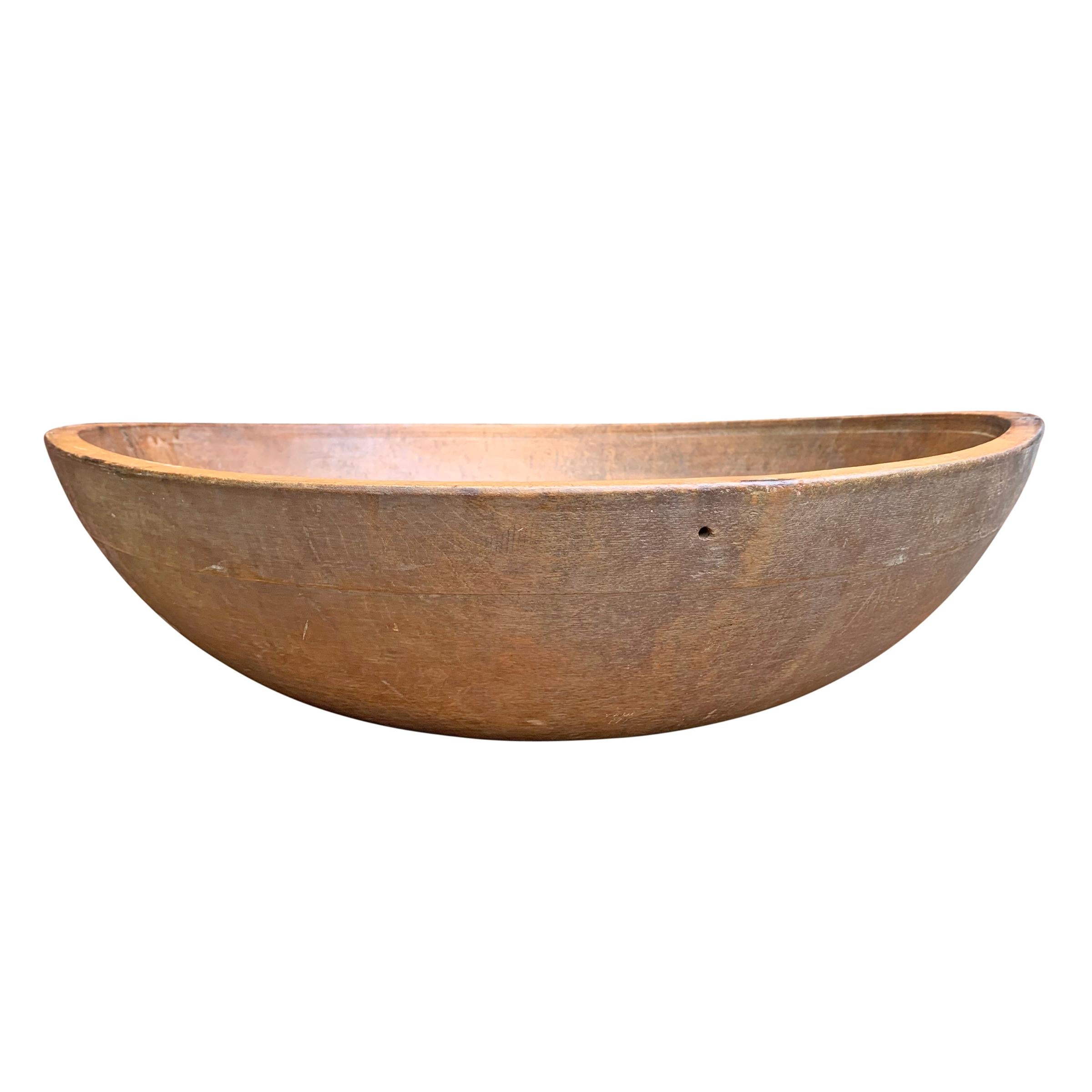 A gorgeous 19th century American turned maple dough bowl with the most incredible patina and thousands of cut marks showing decades of use.