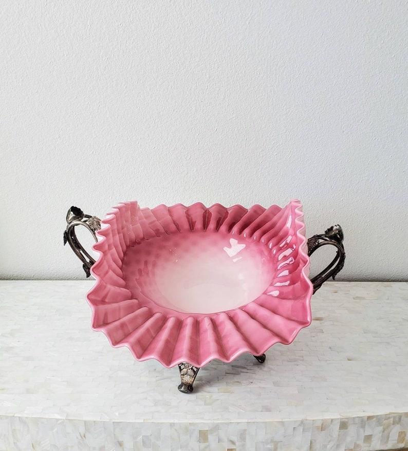 A fabulously impressive pink and white art glass fancy bowl with ruffle crimped scalloped edge and waved form, resting on a fine quality quadruple silver plate white metal stand by E.G. Webster & Son Silver Co. NY, New York. circa 1890

The